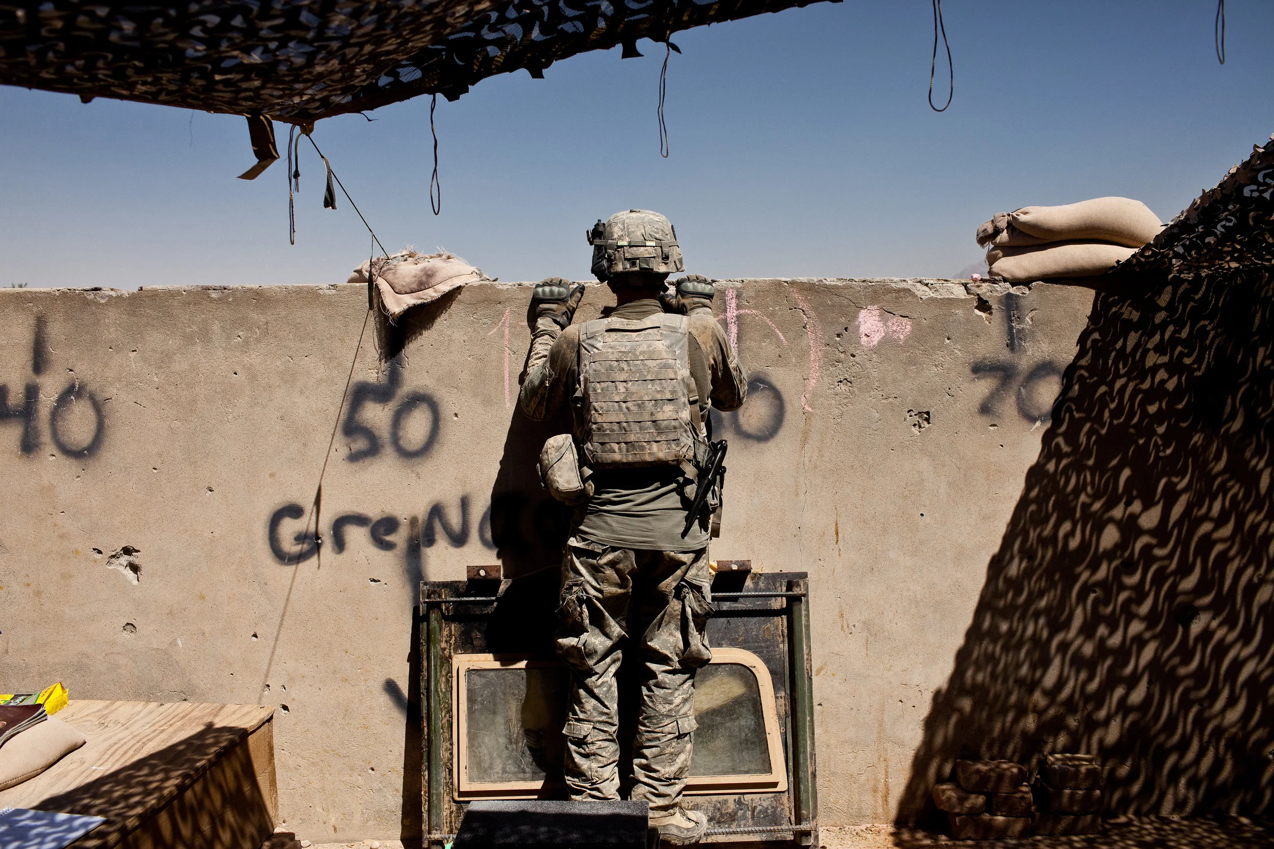  Combat Outpost Nolan, Arghandab Valley, Kandahar Province, Afghanistan. 2010  A soldier from 1-320 Field Artillery Regiment, 101st Airborne, US Army looked out over the battlefield from his fortified position in one of Arghandab's most violent quart