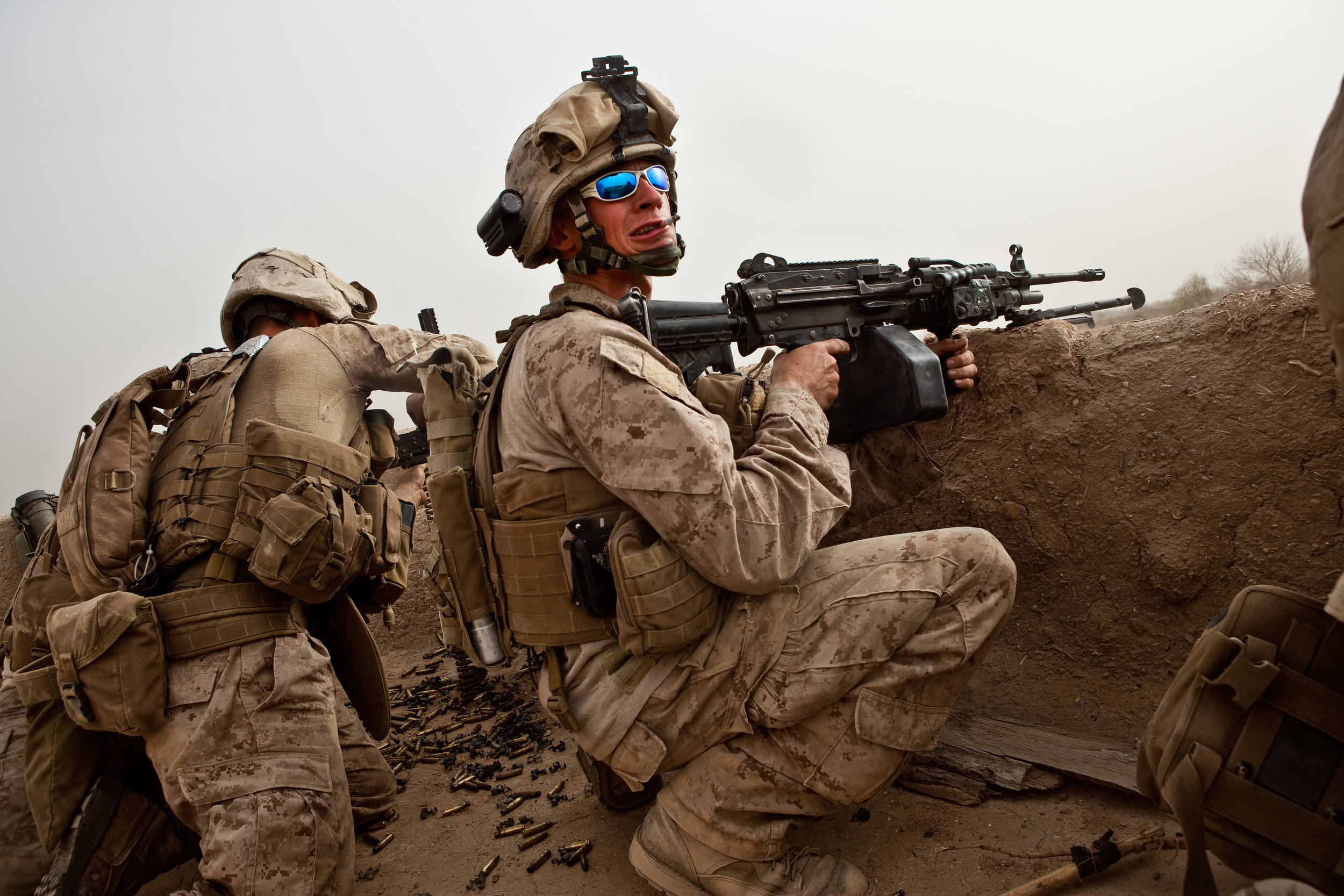  Operation Moshtarek. Marja, Helmand Province, Afghanistan. 2010  Lance Crpl. Chase Welch, Charlie Company 1-6 Marines, yelled to other members of his fireteam between burst from an M-249 SAW during a firefight with suspected Taliban in Marja. 