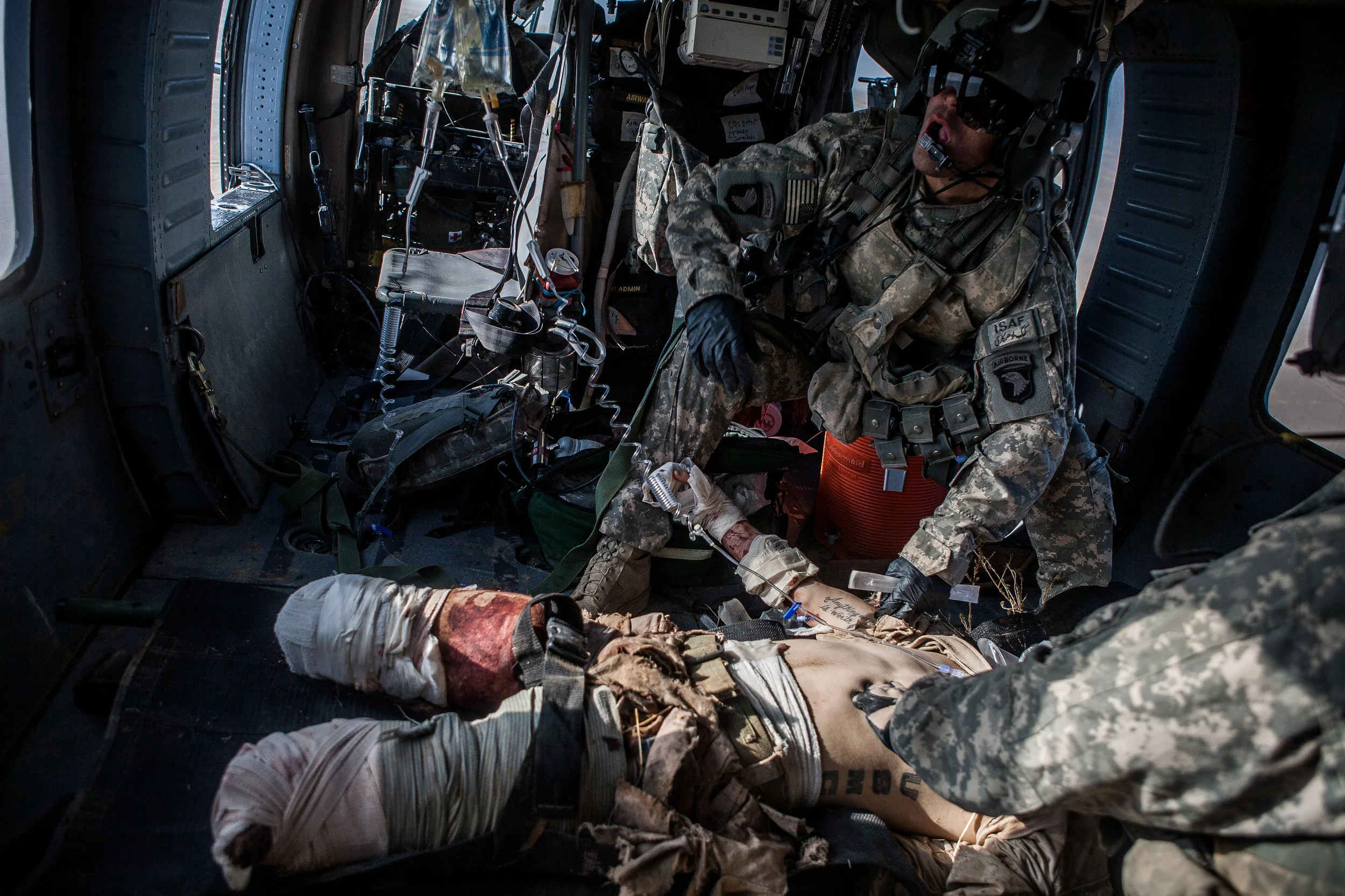  Marja, Helmand Province, Afghanistan. 2010  Flight Medic SGT Ian Bugh of Charlie Co. 6-101st attended to Private Ivan Sears, 20, 2-16 USMC who lost both of his legs after stepping on an improvised explosive device while on a combat patrol in souther