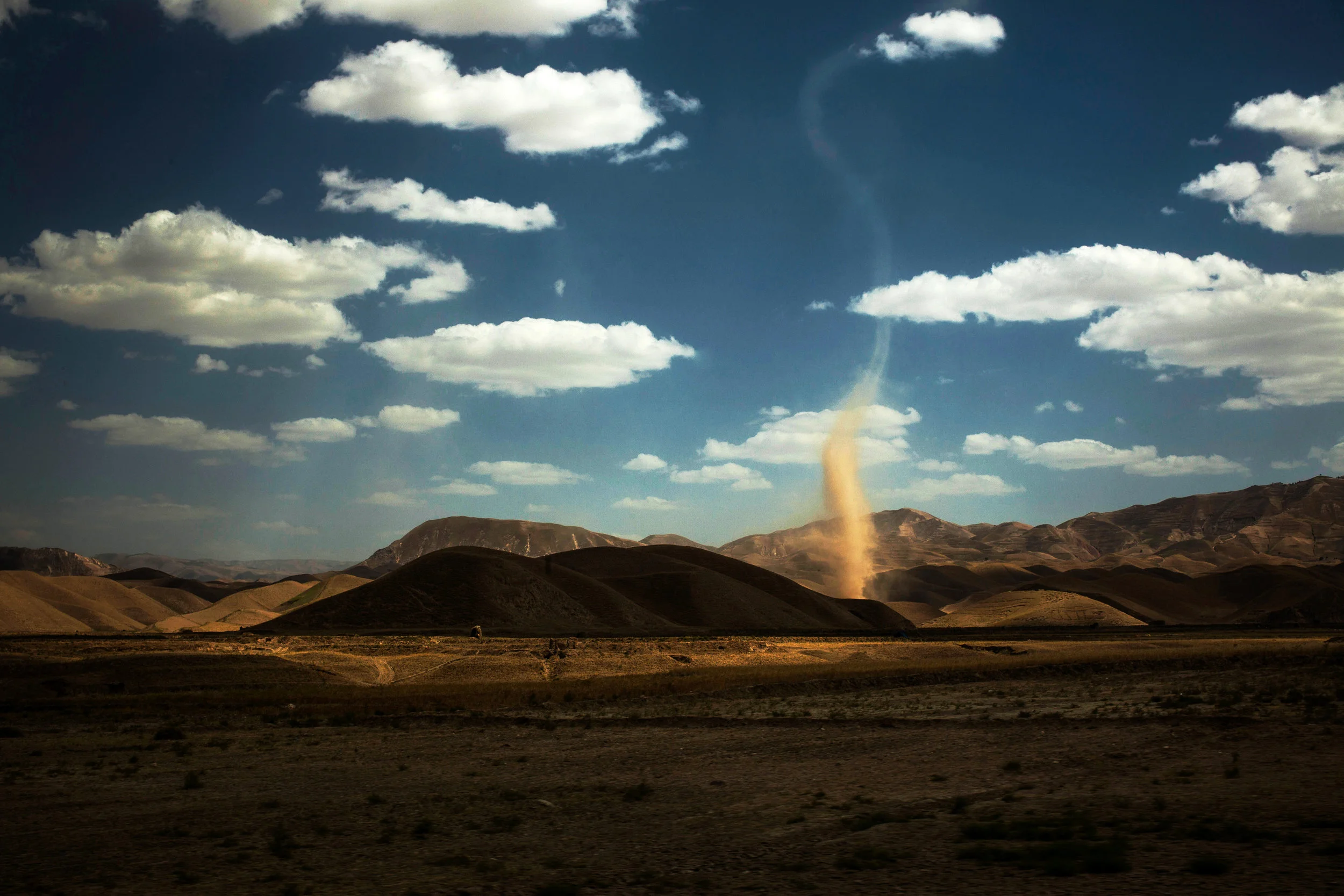  Almar District, Faryab Province, Afghanistan. 2012  A massive dust devil spun it's way across the landscape in Almar district of Faryab province, where by 2012, security had begun to deteriorate rapidly as the Taliban and criminal organizations expa