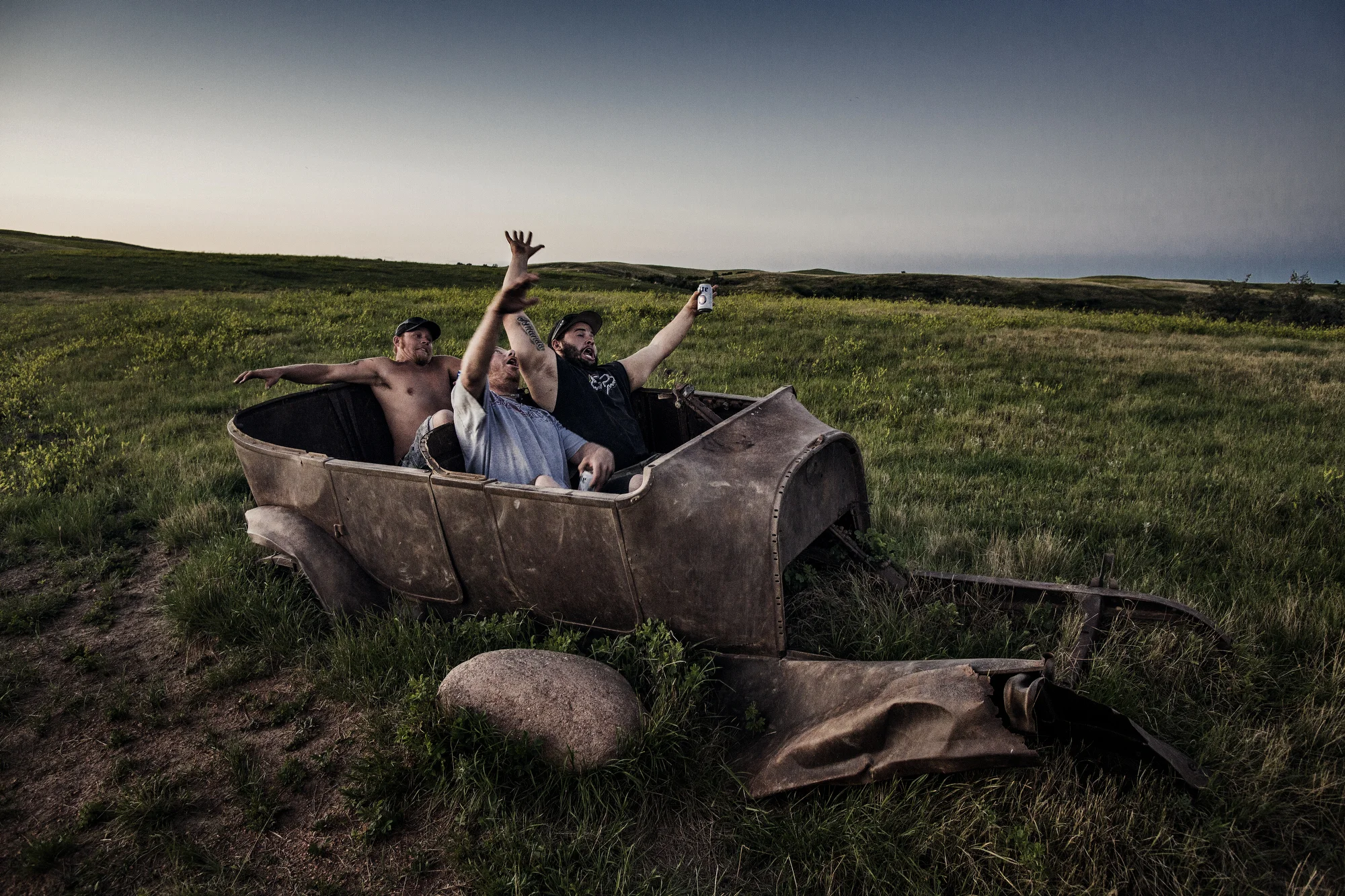  7/26/2014 East of Watford City, North Dakota  "Bam," center, "Lesbo," drinking a beer, and "Phillips," sitting in the backseat, relaxed on a “booze cruise” after their shift on the Raven Drilling oil rig by taking a drive into the badlands near thei