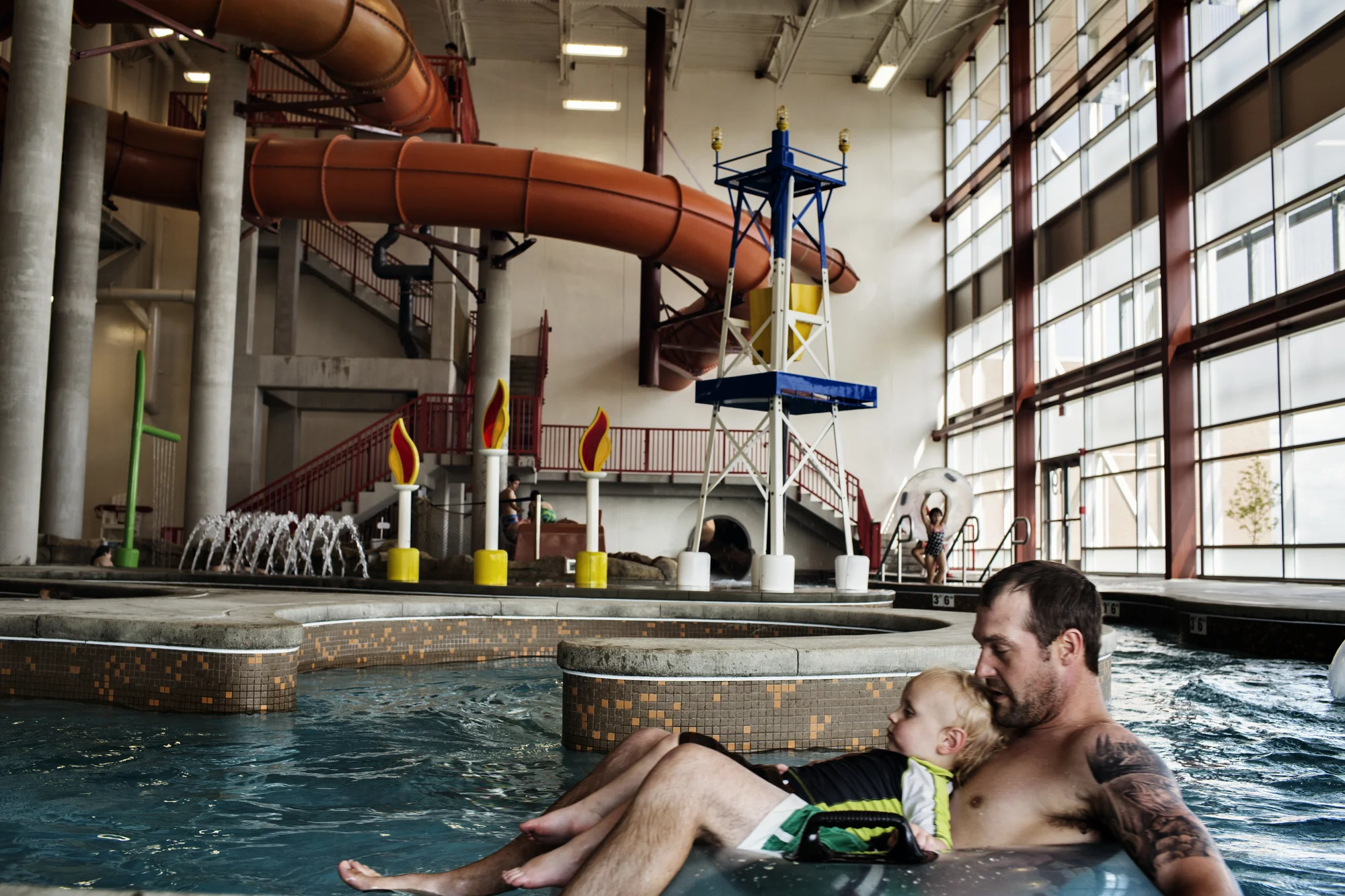  8/5/2014 Williston, North Dakota  A father and his son floated by in the waterpark section of the Williston Area Recreation Center, which prominently features a sculpture of an oil derrick and gas flares as it’s centerpiece. The Arc, as it is known,