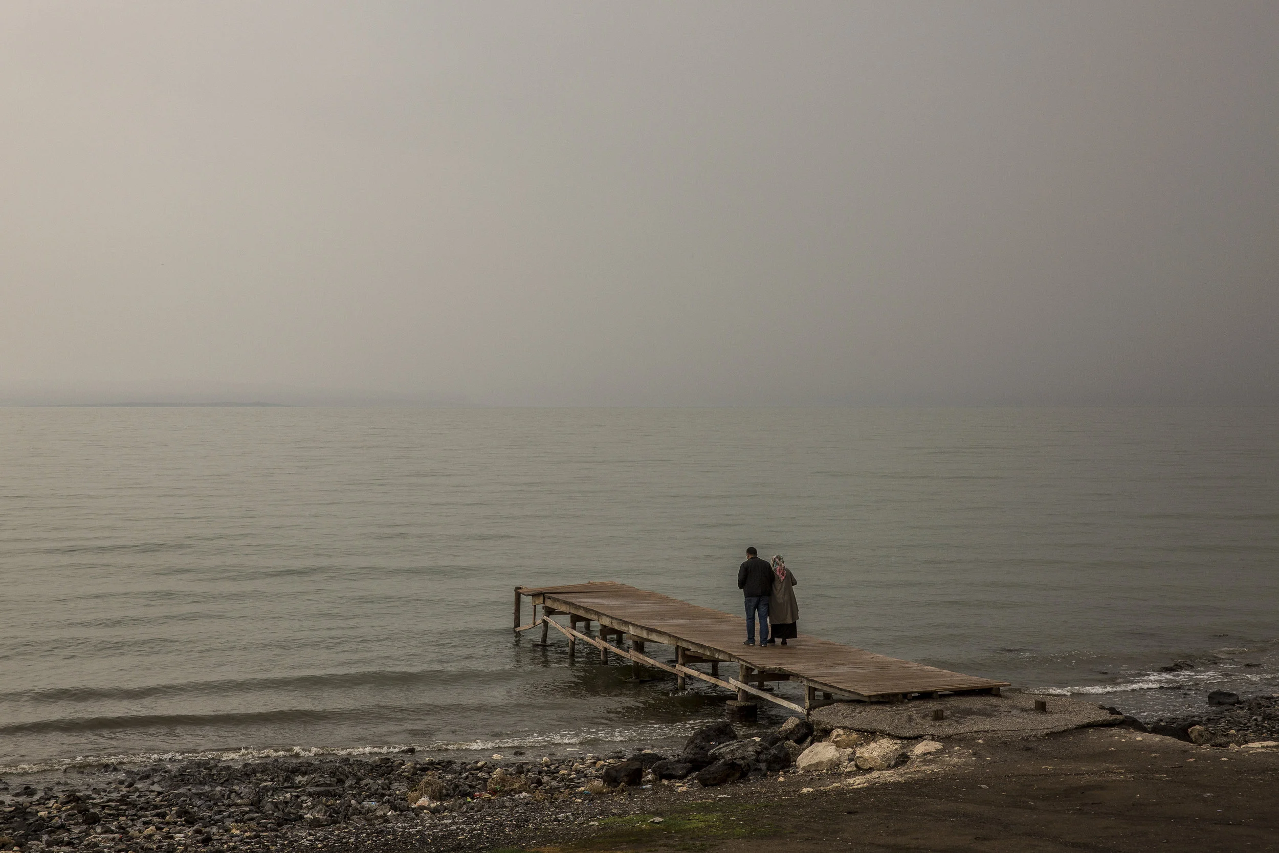  4/9/2015 Van, Turkey  A Turkish couple looked across the lake from a derelict pier along the shores of Lake Van in the town of Erçis. It was recorded in 1916 by British Historians that one of the initial massacres took place here on April 19, 1915 a
