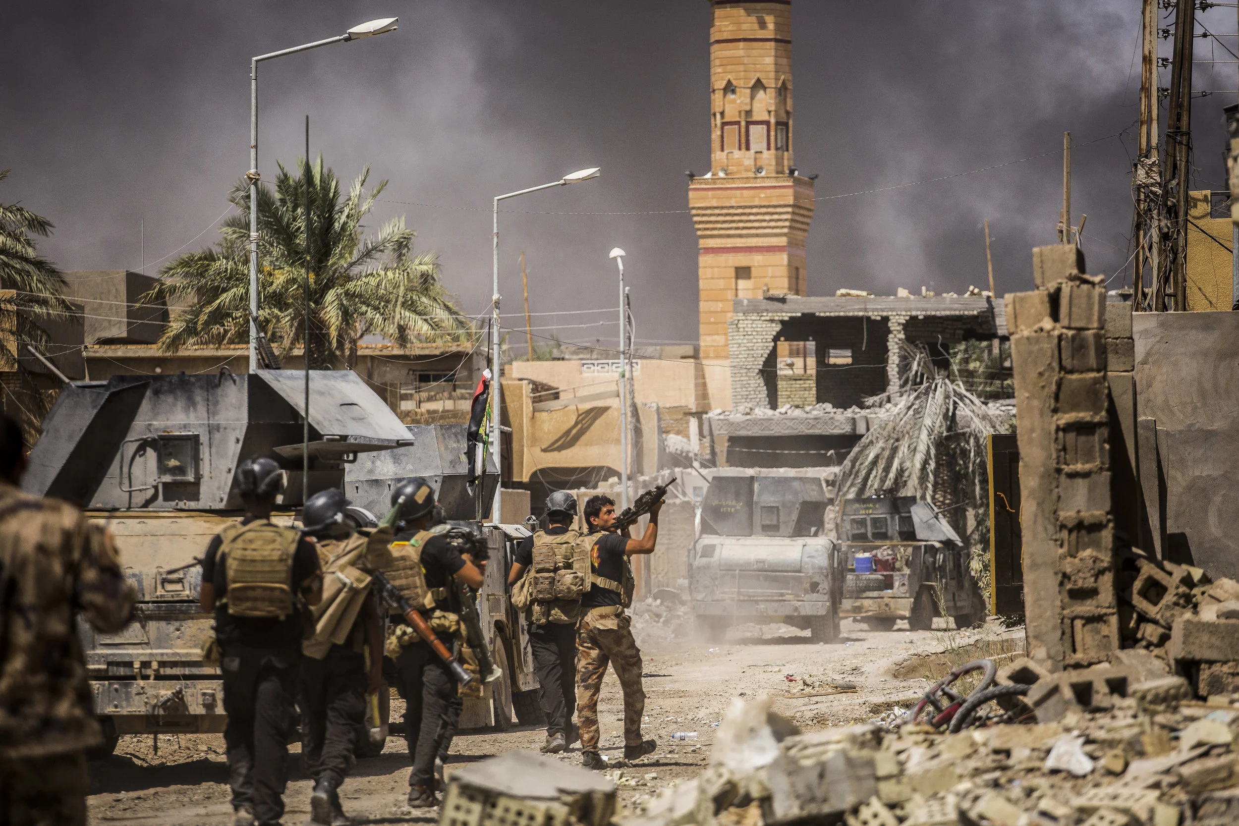  6/25/2016 Fallujah, Iraq  Iraqi Special Forces advanced into the al-Jolan district of Fallujah, as smoke from airstrikes and artillery rose in the background.  Iraqi Security Forces began their push on the ISIS held city of Fallujah on May 23, and h