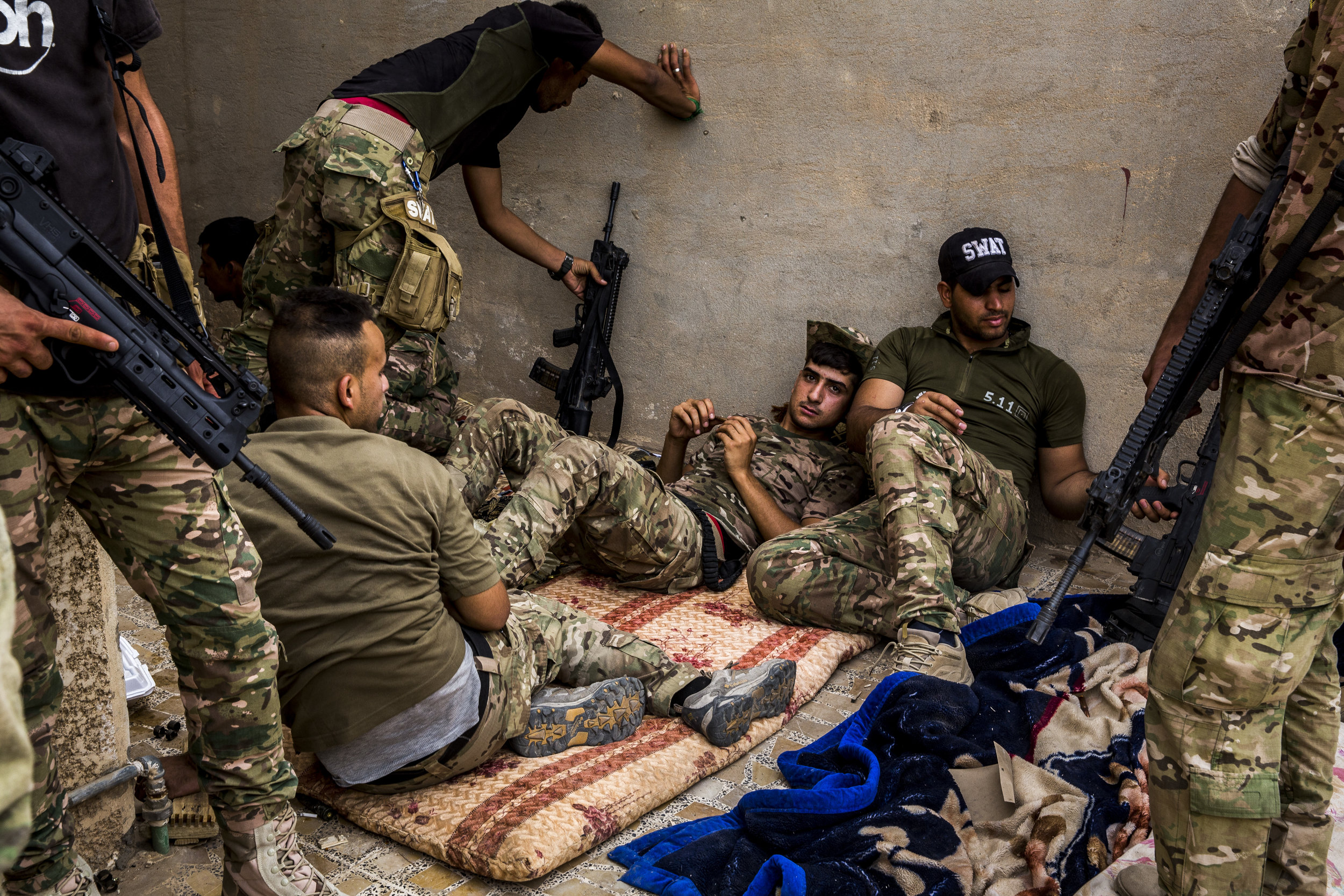  6/19/2016 Fallujah, Iraq  Members of the Iraqi Emergency Response Brigade, part of the Ministry of Interior, rested between operations in the al-Nazal district of Fallujah, Sunday. 