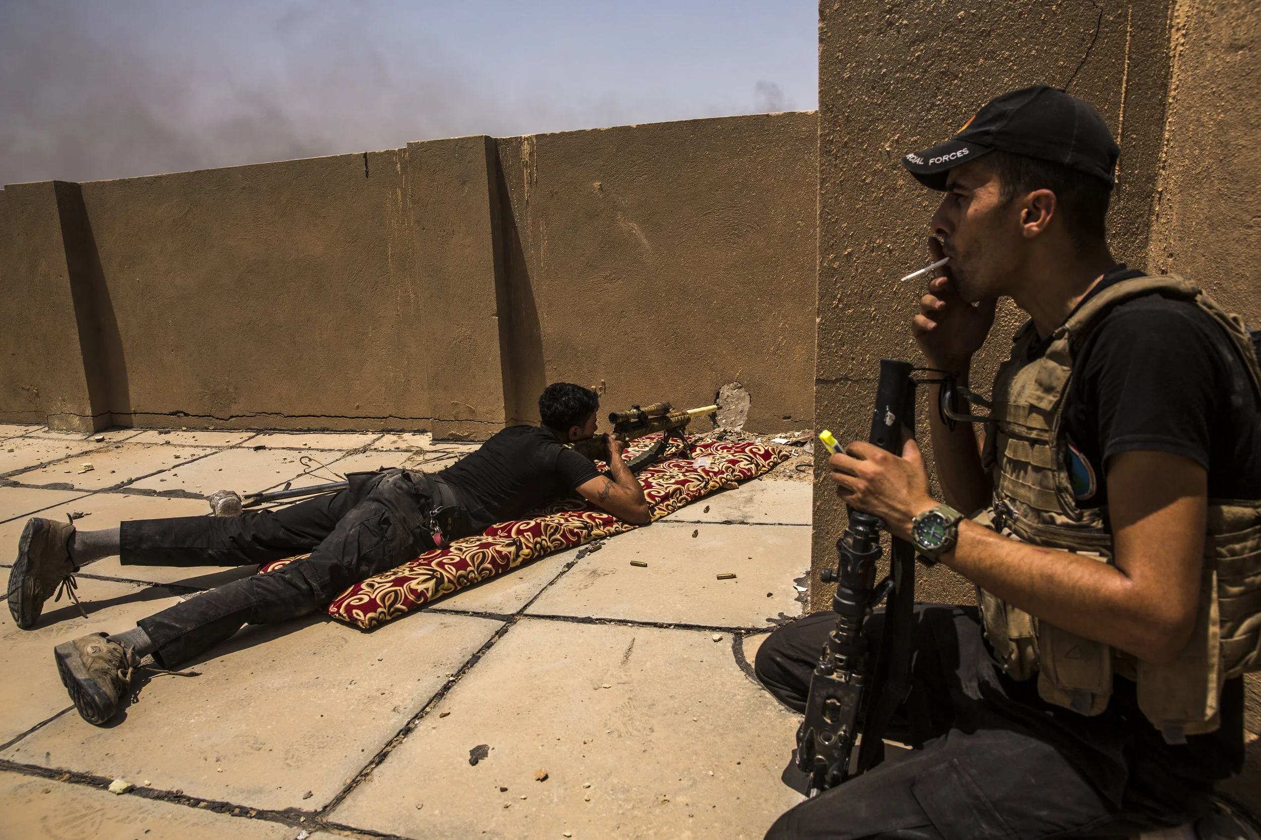  6/25/2016 Fallujah, Iraq  An Iraqi Special Forces sniper fired on a suspected ISIS position from a rooftop on the frontlines as his unit pushed deeper into the al-Jolan neighborhood of Fallujah, Saturday. 