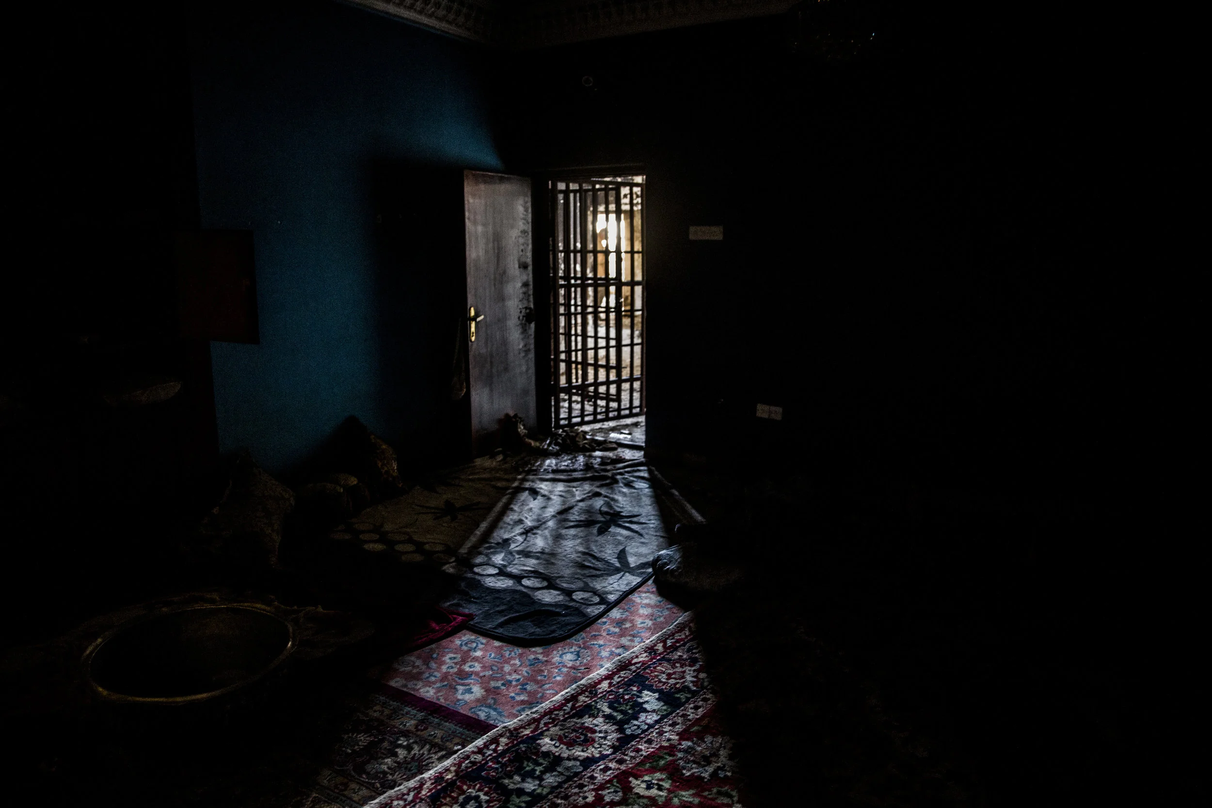  6/29/2016 Fallujah, Iraq  Sunlight filtered through the bars on a cell door in a former ISIS prison in the al-Mualamin district of central Fallujah. The complex, which was spread over three large residential buildings, was among other things, a cent