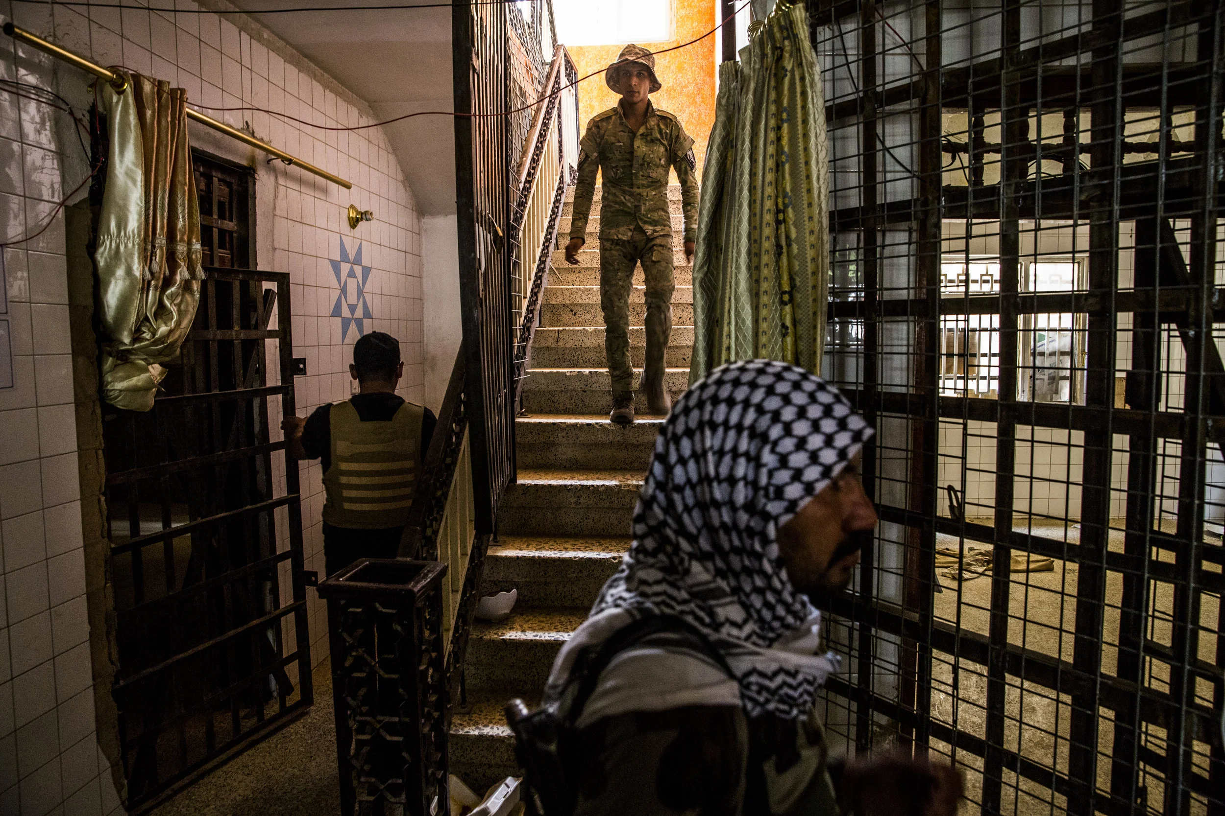  6/19/2016 Fallujah, Iraq  Members of the Iraqi Emergency Response Brigade toured through a former ISIS prison in Fallujah's al-Nazal district. The building held several makeshift cells, as well as a courtroom. 