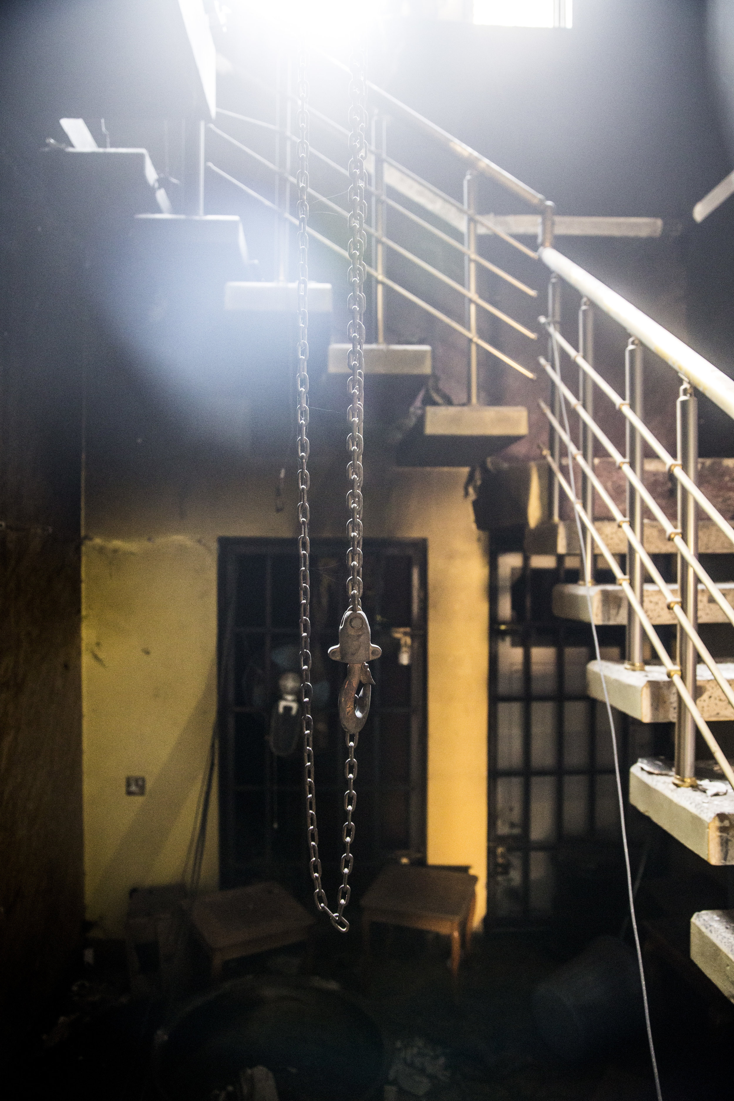  6/29/2016 Fallujah, Iraq  A hook connected to a winch, used for hoisting prisoners during torture, hung from the ceiling in the stairway of a home that had been used by ISIS as a prison complex, in the al-Mualamin district of central Fallujah Wednes