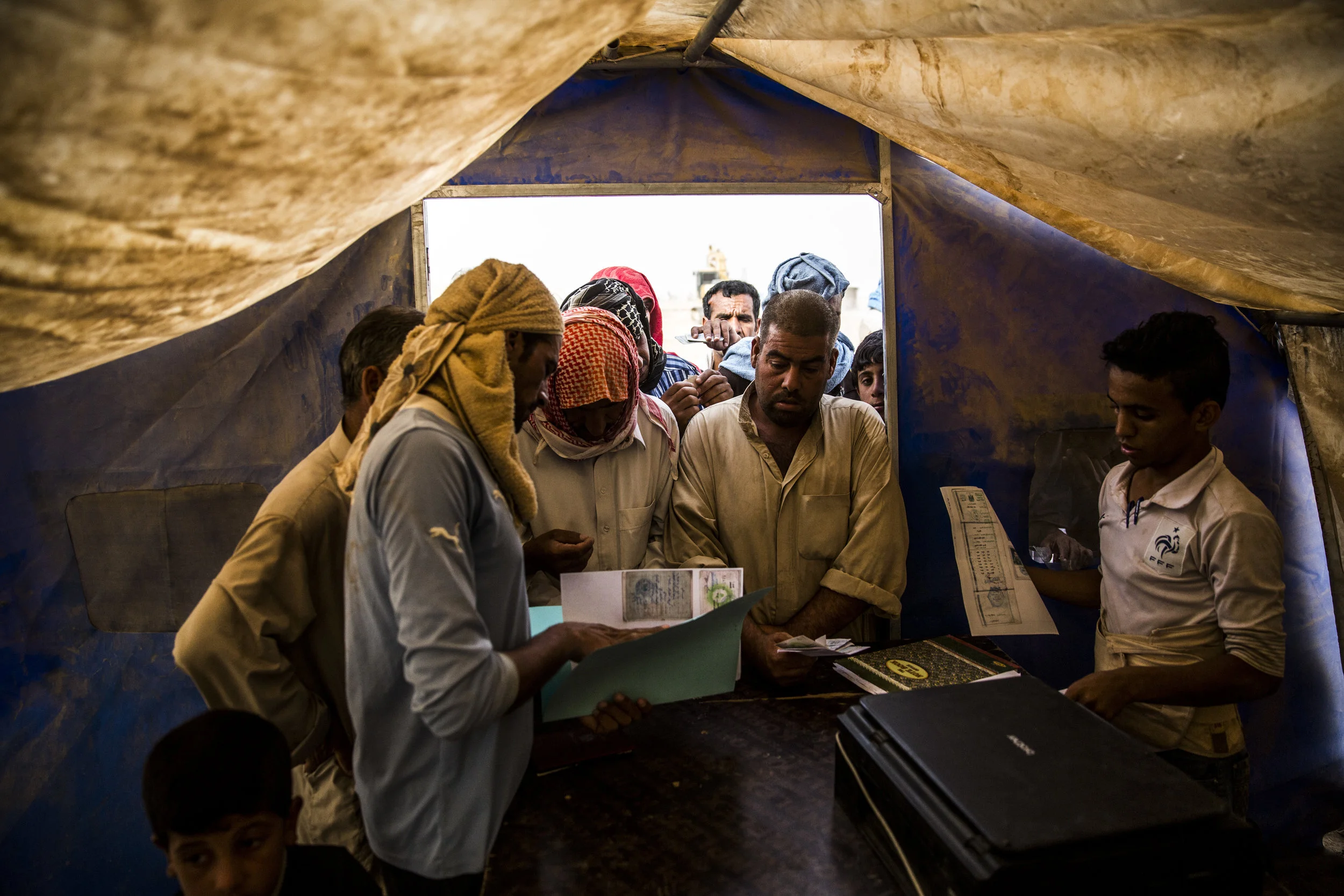  6/28/2016 Habbaniyeh, Iraq  Internally displaced Sunni’s registered for aid at a dusty IDP camp in Habbaniyeh. The battle for Fallujah has displaced hundreds of thousands, with no clear indicators as to when people will be able to return home to the