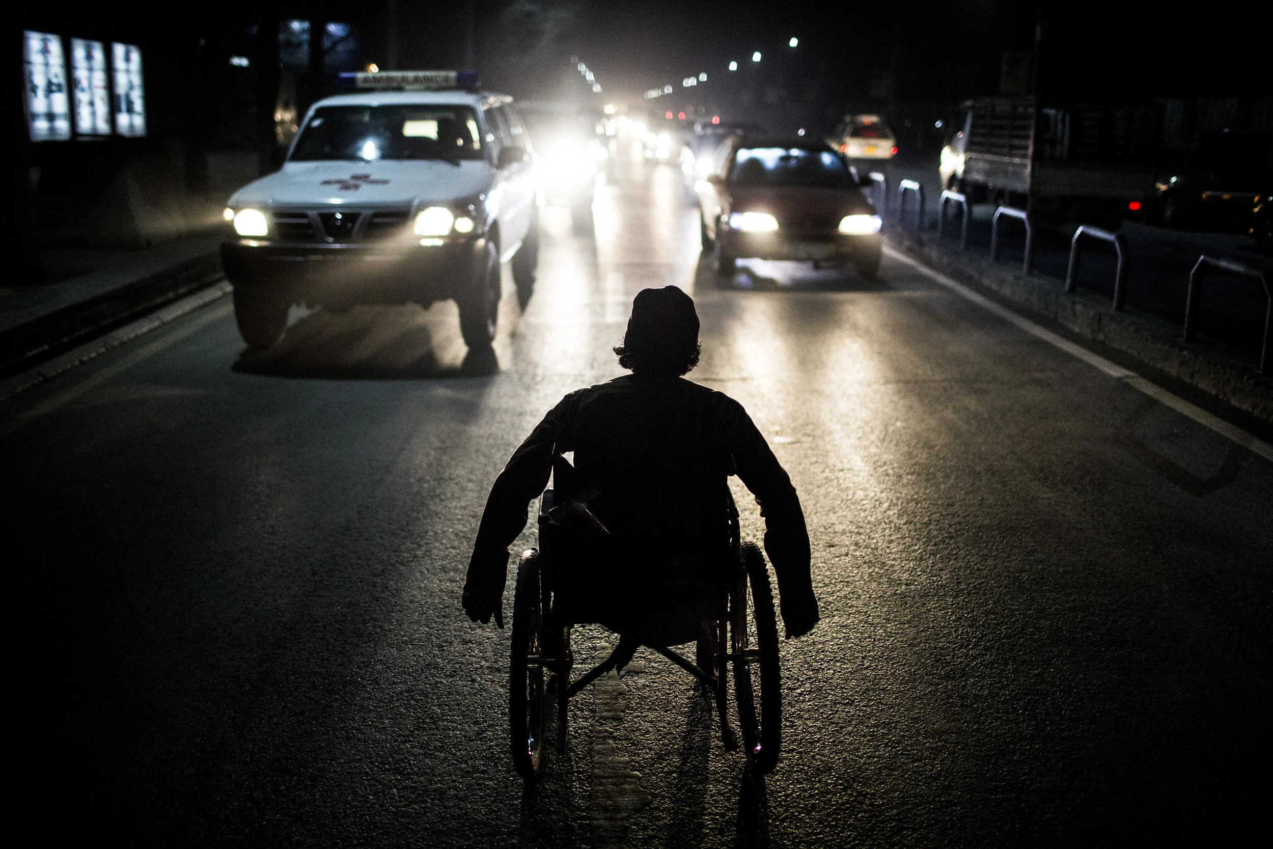 12/9/2014 Kabul, Afghanistan Fardeen, 24, a former Afghan National Policeman who was wounded by an IED in Paktika province, begged for change near the square where the US Embassy is located in Kabul, Afghanistan. Once a Sergeant in the police, Mr. Fardeen now says that his family has disowned him, and he begs at night in order to not be seen by people who might recognize him. Despite losing his legs in the line of service, Fardeen says he receives no pension or compensation from the Afghan government.