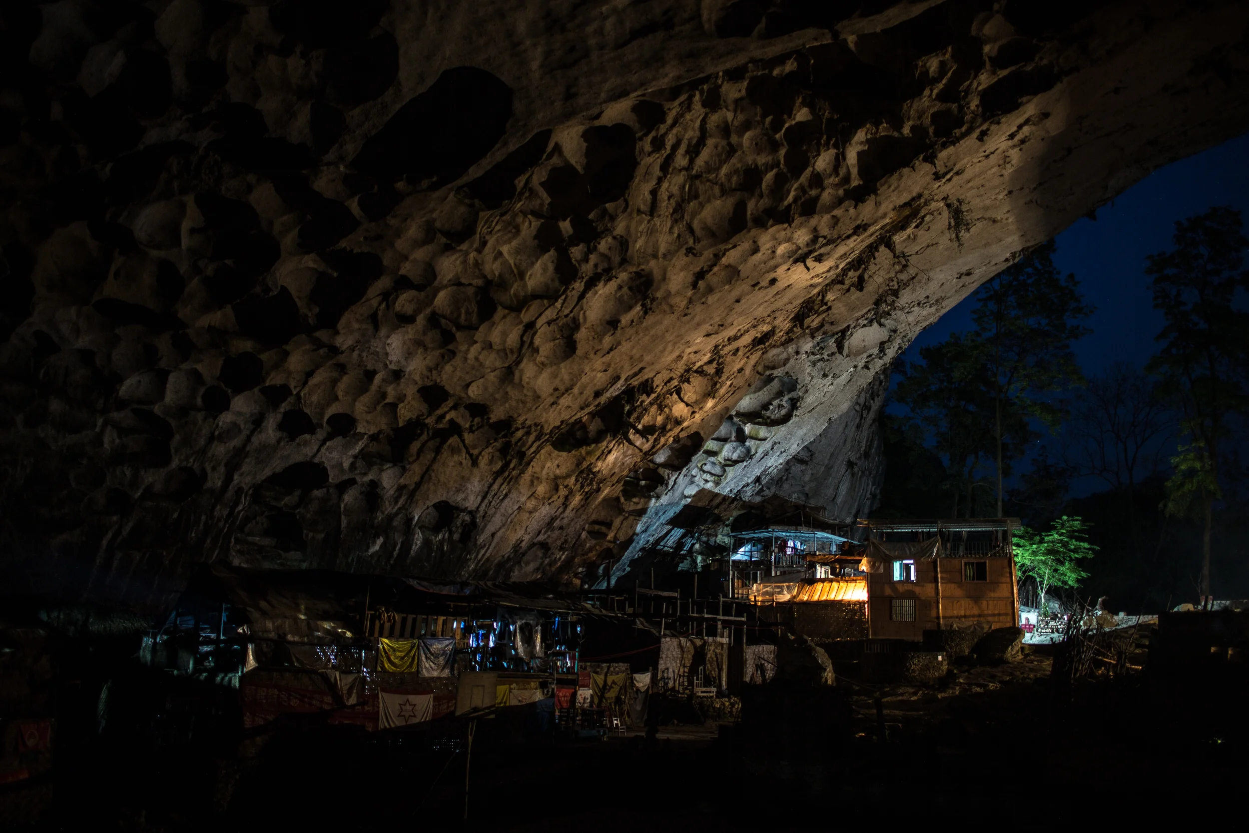 4/12/2018 Zhongdong, Guizhou Province, China. The interior of the Zhong cave was illuminated by resident's electric lights after sunset. Frank Beddor Jr, an American businessman from Minnesota who visited Zhongdong for the first time in 2003, donated the cave's electrical infrastructure as well as it's school, which is now closed.