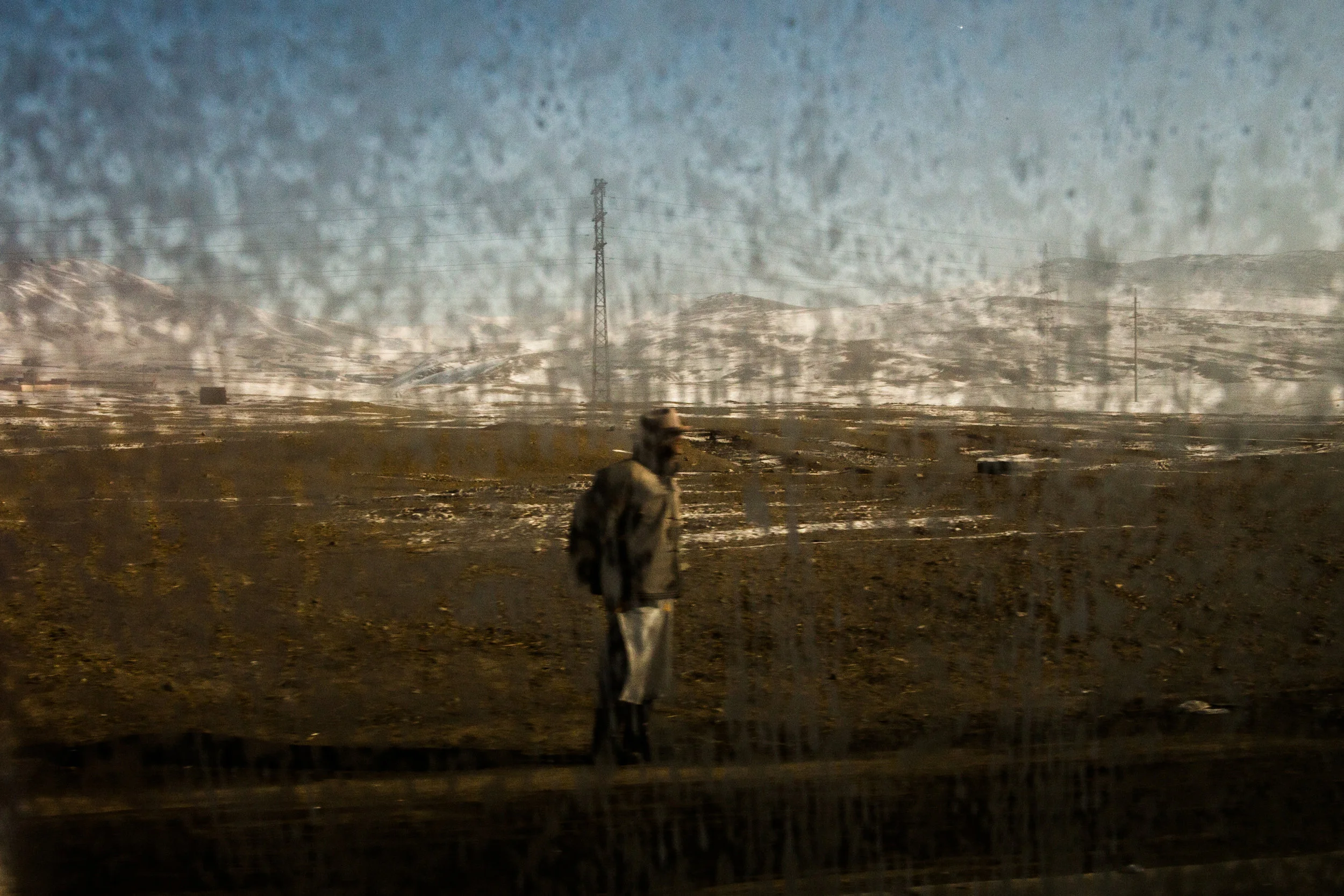  2/20/2018 Ulaanbaatar, Mongolia  A man could be seen through frost on a car window as he stood on the side of the road to the Nalaikh coal mines on the outskirts of Ulaanbaatar, in mid February. The Nalaikh coal deposits are just 40km from the cente