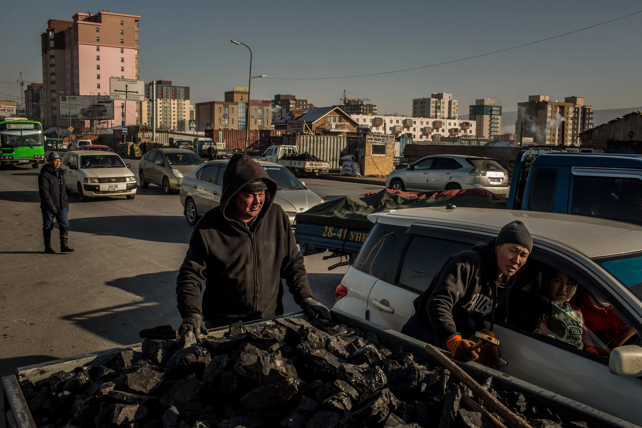  2/20/2018 Ulaanbaatar, Mongolia  Raw coal sellers negotiated prices with passing customers at the Shar Khad Market in Ulaanbaatar, Mongolia. Buyers typically purchase one entire flatbed of coal at a time, weighing 1.3 tons—enough to last a single fa