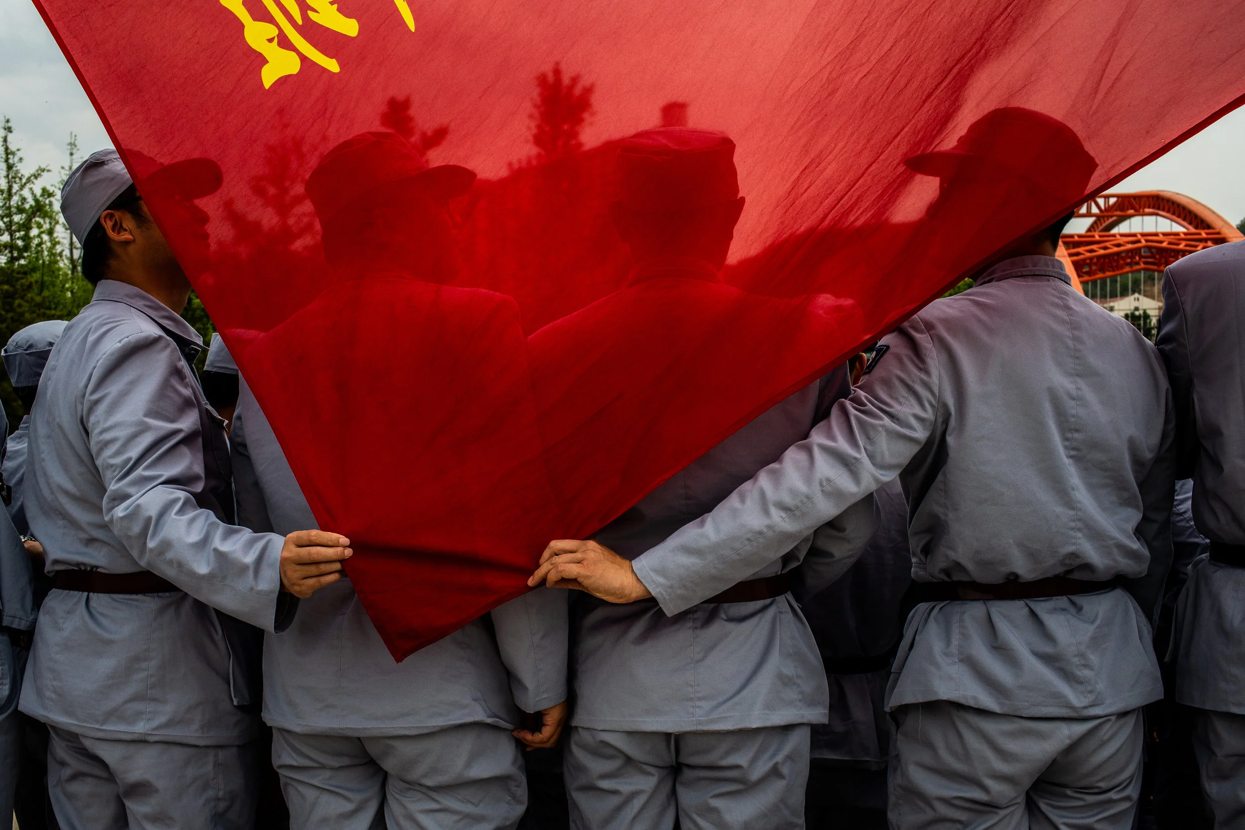  5/8/2018 Yan'an, Shaanxi Province, China  Staff from the Sichuan Academy of Aerospace Technology, a research and development and production complex for the main contractor for China's space program held their group's flag while taking a picture toge