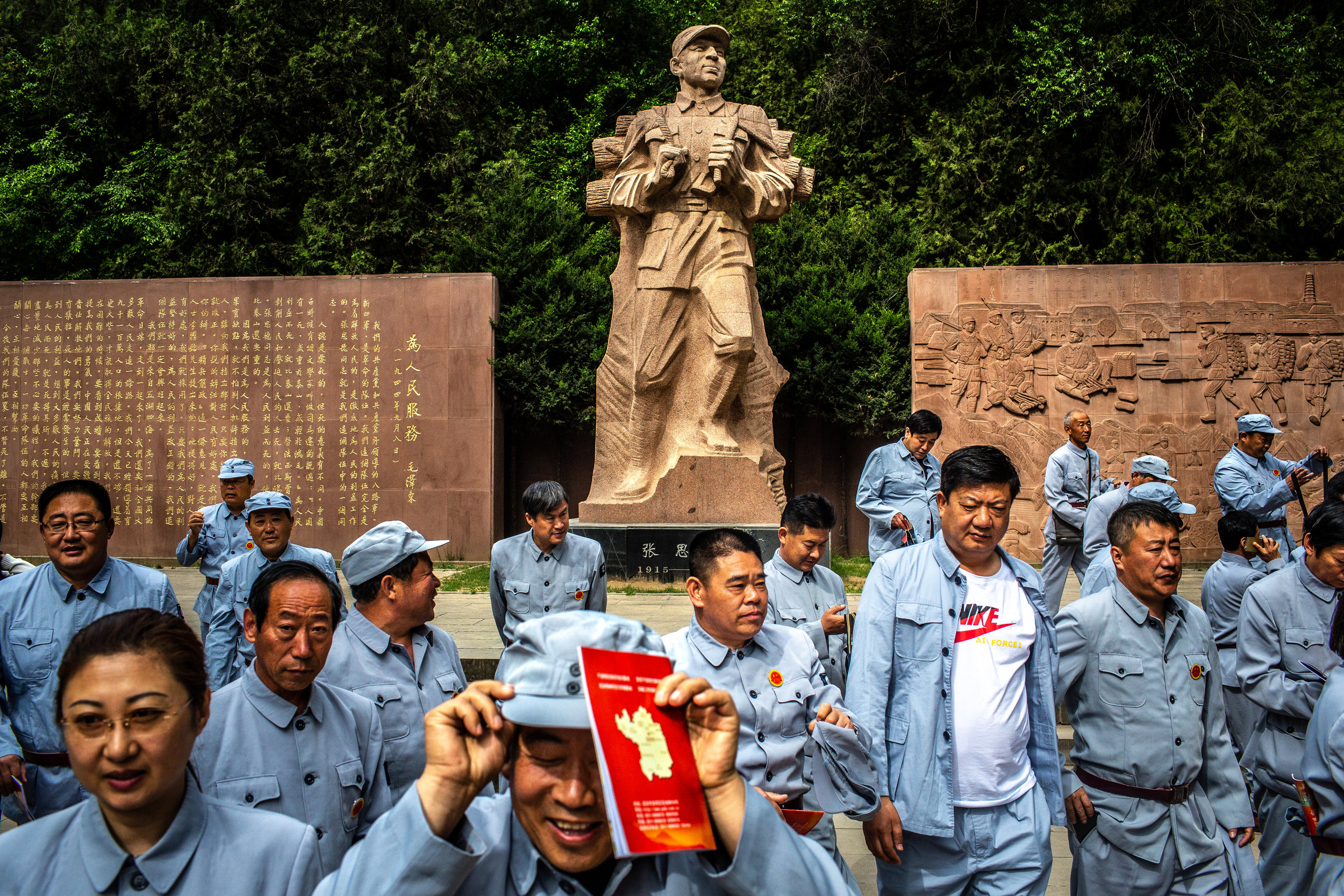  5/8/2018 Yan'an, Shaanxi Province, China  Members of a tour group participating in a red tour of China's communist history visited a statue in Yan'an commemorating the Chinese Communist Party's defense of the city against the Kumintang government du