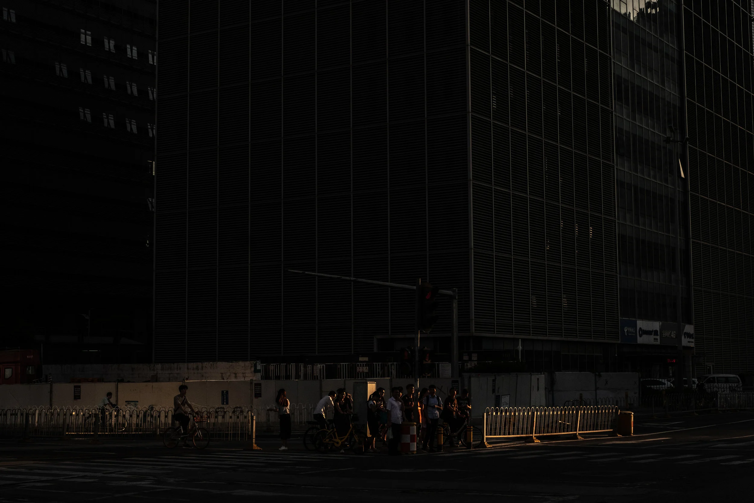  5/21/2018 Shenzhen, China  People stood on a corner in Shenzhen's Tech district, where Chinese Internet giants Tencent and Baidu are based. China's internet is central to it's population's everyday lives, but at the same time, it is highly censored 