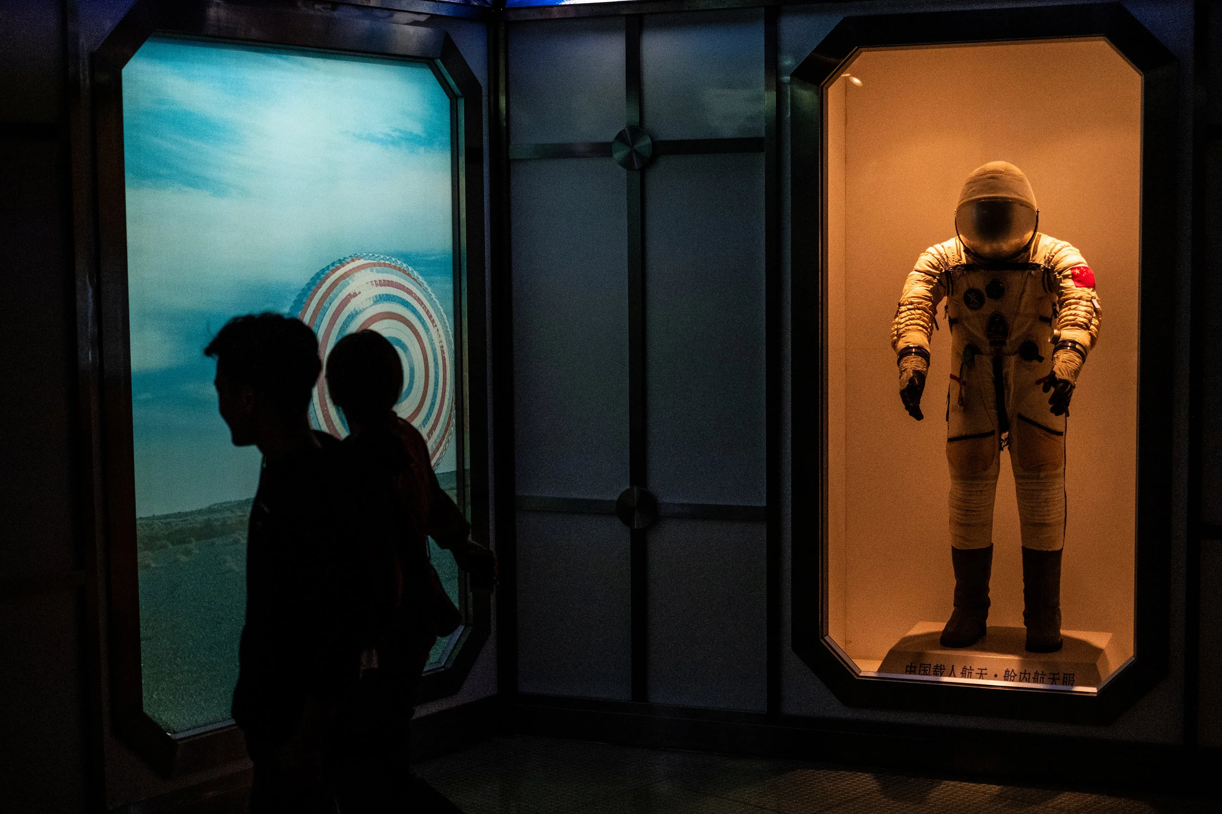  5/20/2018 Shanghai, China.  Visitors walked past a replica of a Chinese Taikonaut space suit on displace at the Shanghai Science and Technology Museum's space exploration section. China has been aggressively pursuing a manned spaceflight program, pl