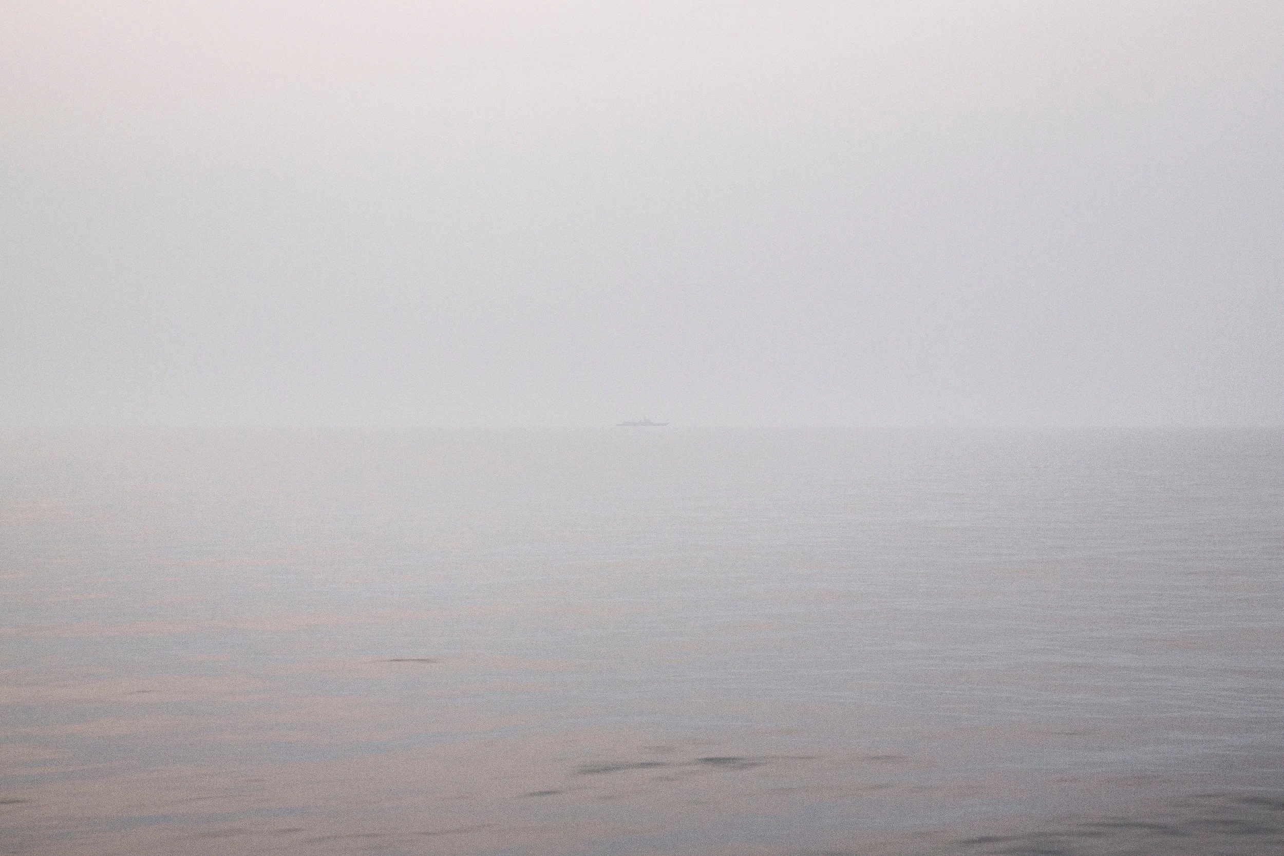  3/23/2016 Aboard the USS Chancellorsville in the South China Sea  A Chinese Peoples Liberation Army (Navy) Jiangkai II Frigate, hull number 575, held a position in the hazy twilight off of the port side of the USS Chancellorsville at it transited th