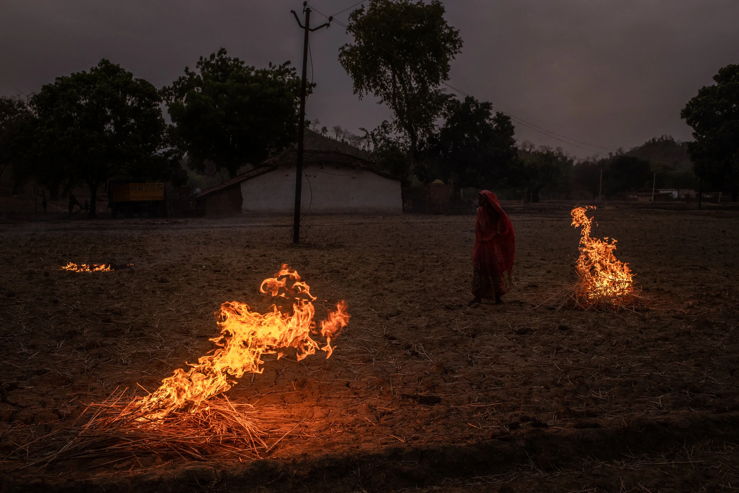  6/15/2019 Jugail, Uttar Pradesh, India.   A woman burned dry husks to fertilize the land in Jugail, Uttar Pradesh in the hopes that the summer monsoon will bring rain to the region.    Residents of the Chopan Block in Uttar Pradesh, about 120km sout