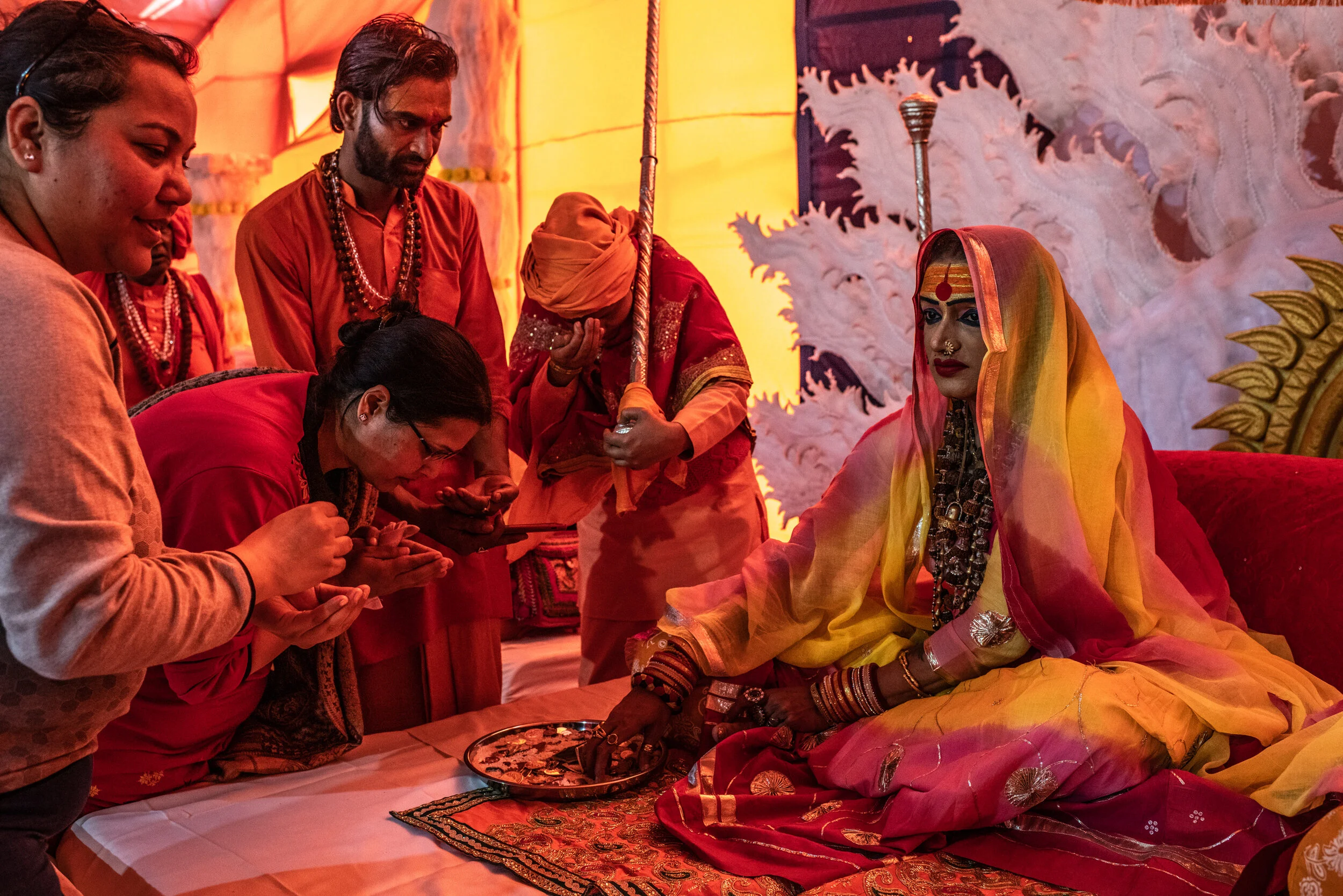  2/5/2019 Prayagraj, Uttar Pradesh, India  Laxmi Narayan Tripathi, right, the chief of the Kinnar Akhara, received alms and gave out blessings to devotees during a large gathering in a receiving tent at the Kinnar Akhara's camp, in the Kumbh Nagari (