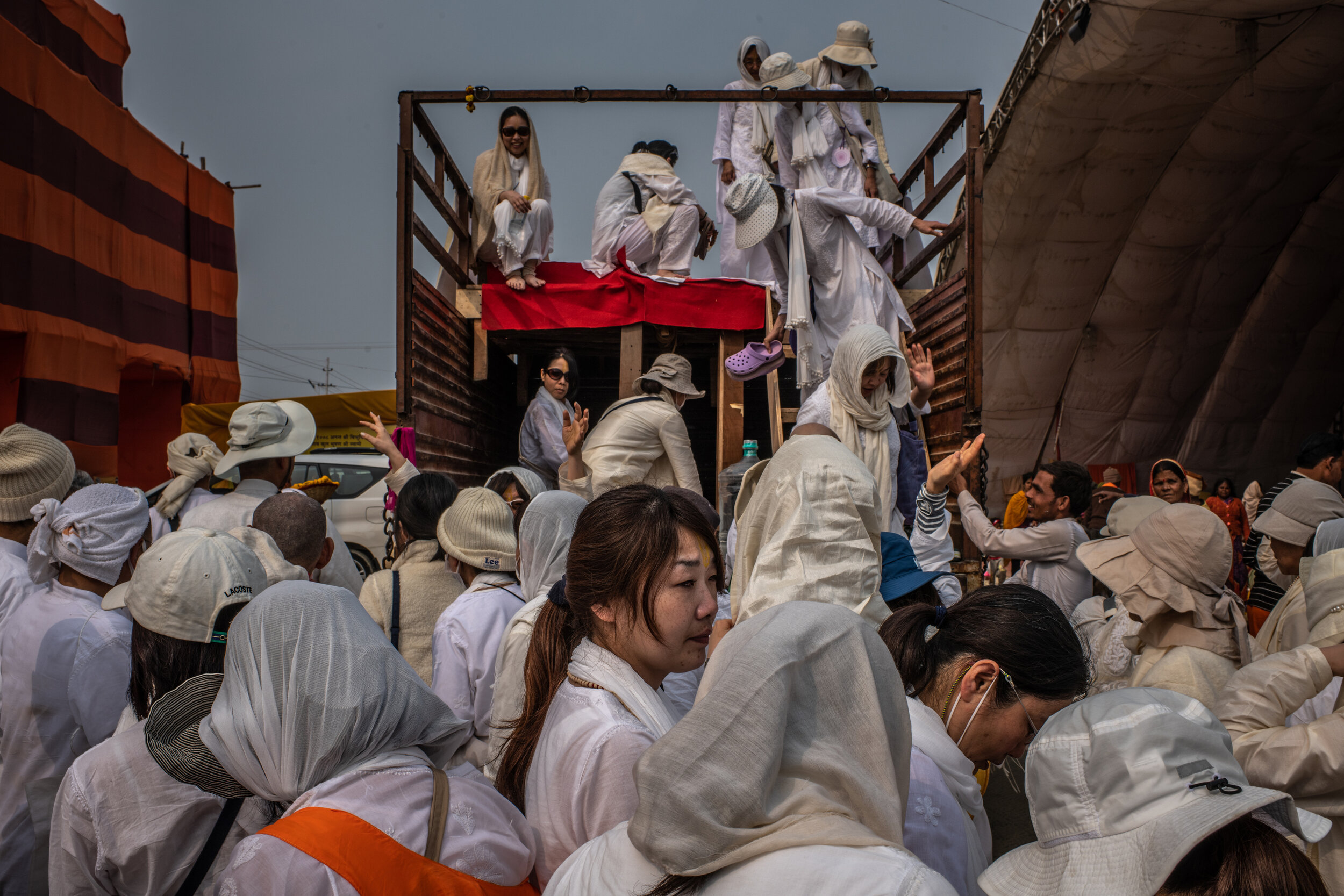  2/5/2019 Prayagraj, Uttar Pradesh, India  Visiting Japanese Hindu devotees climbed out of a truck as their group visited an Akhara located in the Kumbh Nagari—the makeshift city that springs to life to accommodate all of the religious camps and pilg