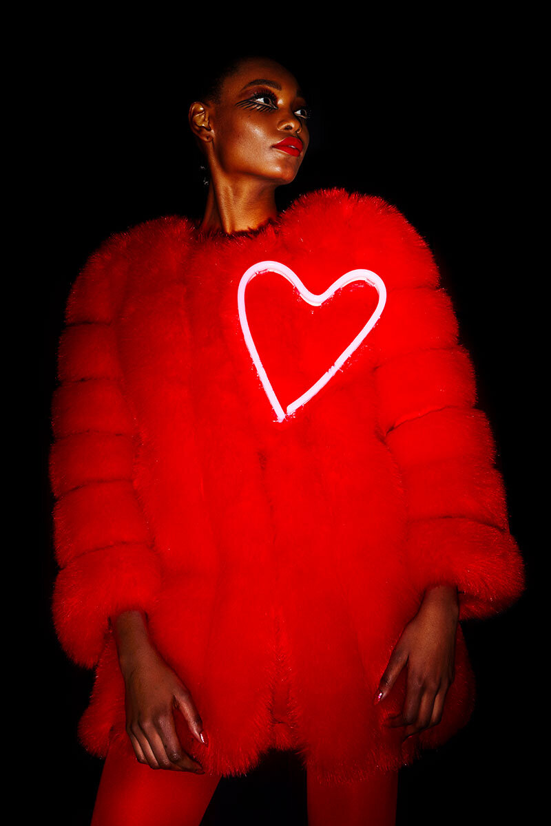 A model in a red fur photographed backstage at Christian Cowan Fall/Winter 2018.