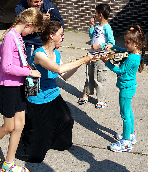  Alison Wallace shows off her Scandinavian-style authentic Hardanger fiddle to a young admirer 