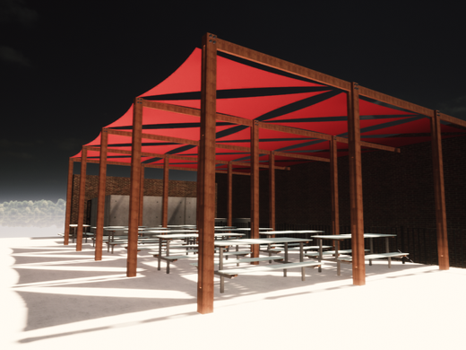 An outdoor covered area with red canopy and multiple picnic tables on a sandy surface.