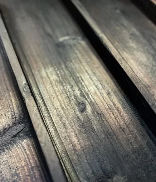 Close-up of weathered dark wooden planks.