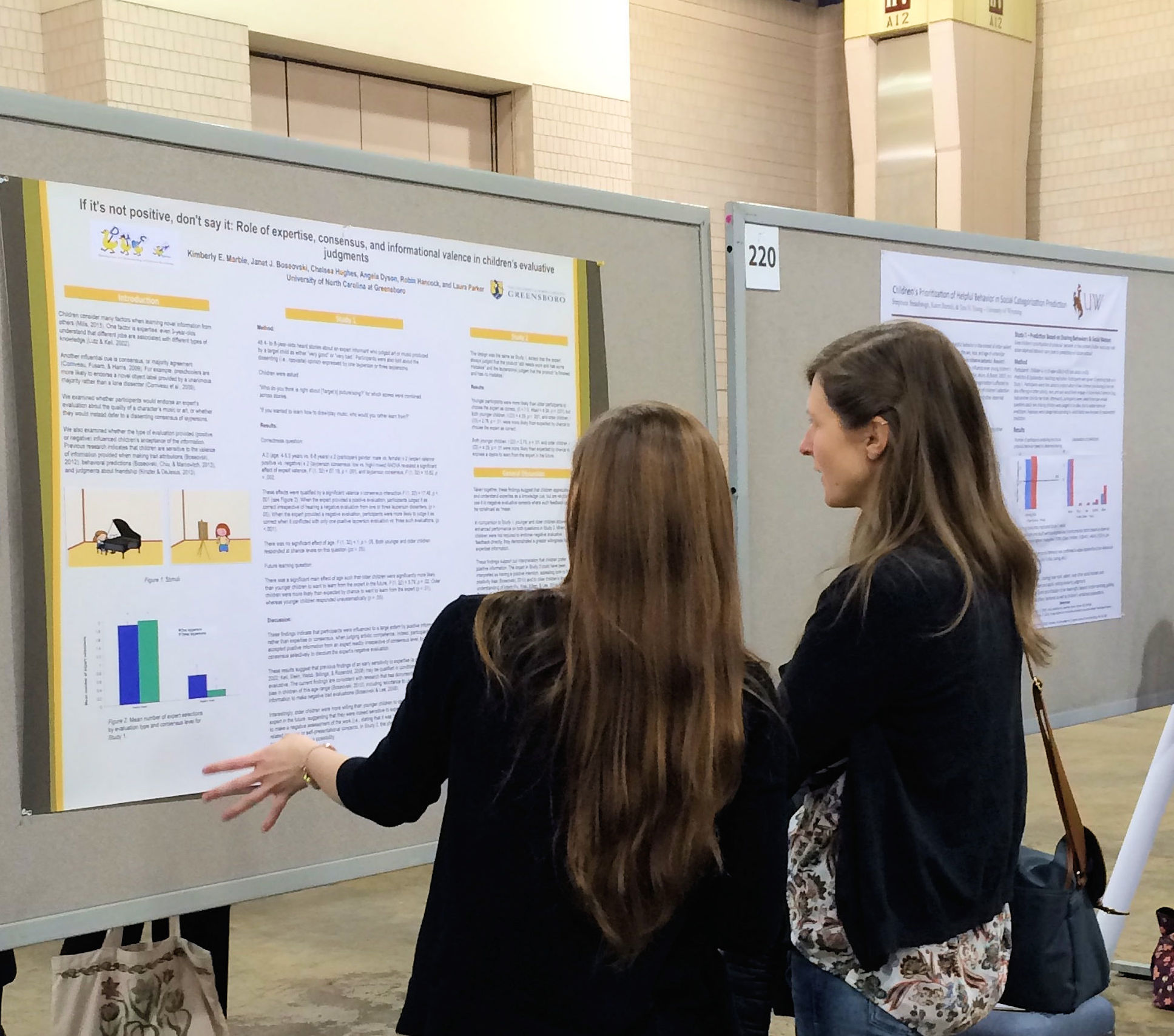 Kimmy Marble explains her research to a colleague
