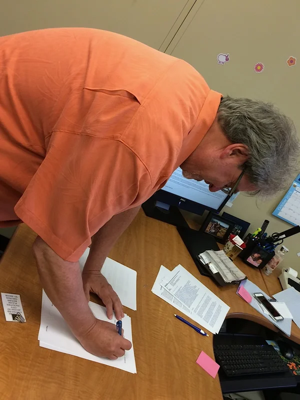 Mark Herrier, LTP president, signs documents at City Hall that allow LTP to purchase a deed of trust on the theater for $1. The Lompoc City Council voted to approve the sale of the deed Tuesday, Oct. 6.