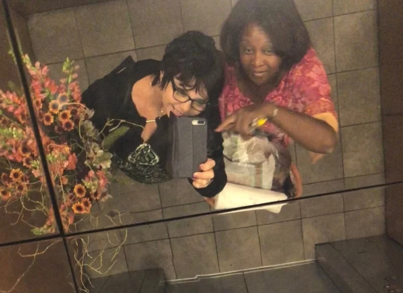 Vice President and Administrative Director Sandy Villa and Co-founder Teri Shepherd having fun taking pictures in preparation for the Memory Fair in Union City, CA on October 20, 2018.