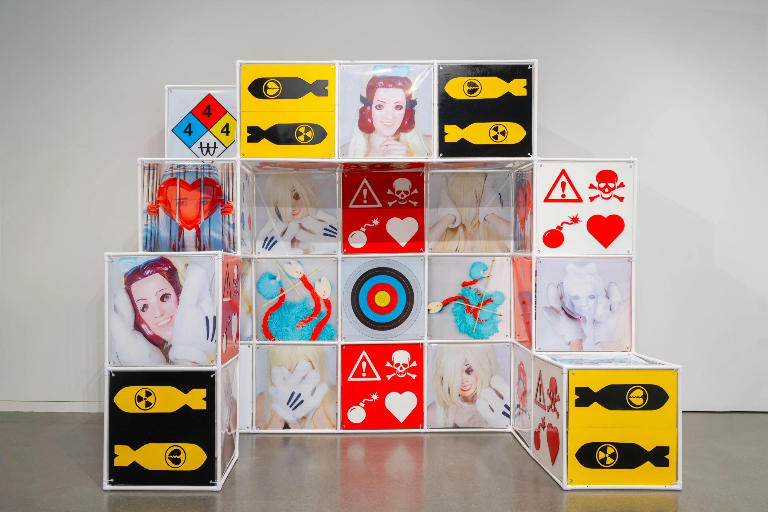 An Attraction (2025) Installation with polyvinyl chloride pipe, inkjet prints on celluloid film, maple plywood coated in federal standard Occupational Safety and Health Administration (OSHA) enamel paint and polyurethane high gloss, silver gromme