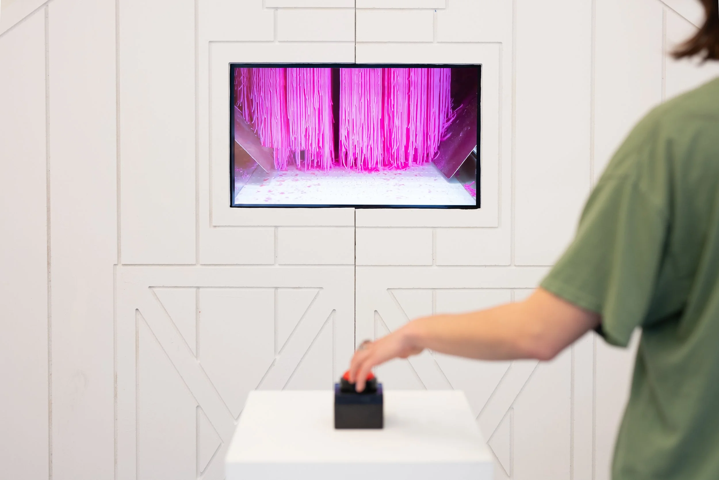 Running Scared Set Piece (2025) Multimedia installation with melamine white particle board, polyurethane gloss, plywood, monitor, button, pedestal 11ftx7ft