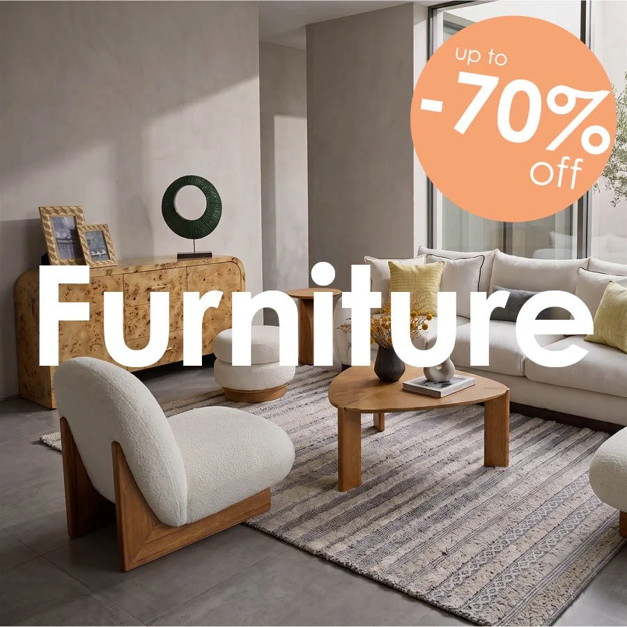 Modern living room featuring a white bouclé accent chair, oak coffee table, and beige sofa with a 70% off sale banner.