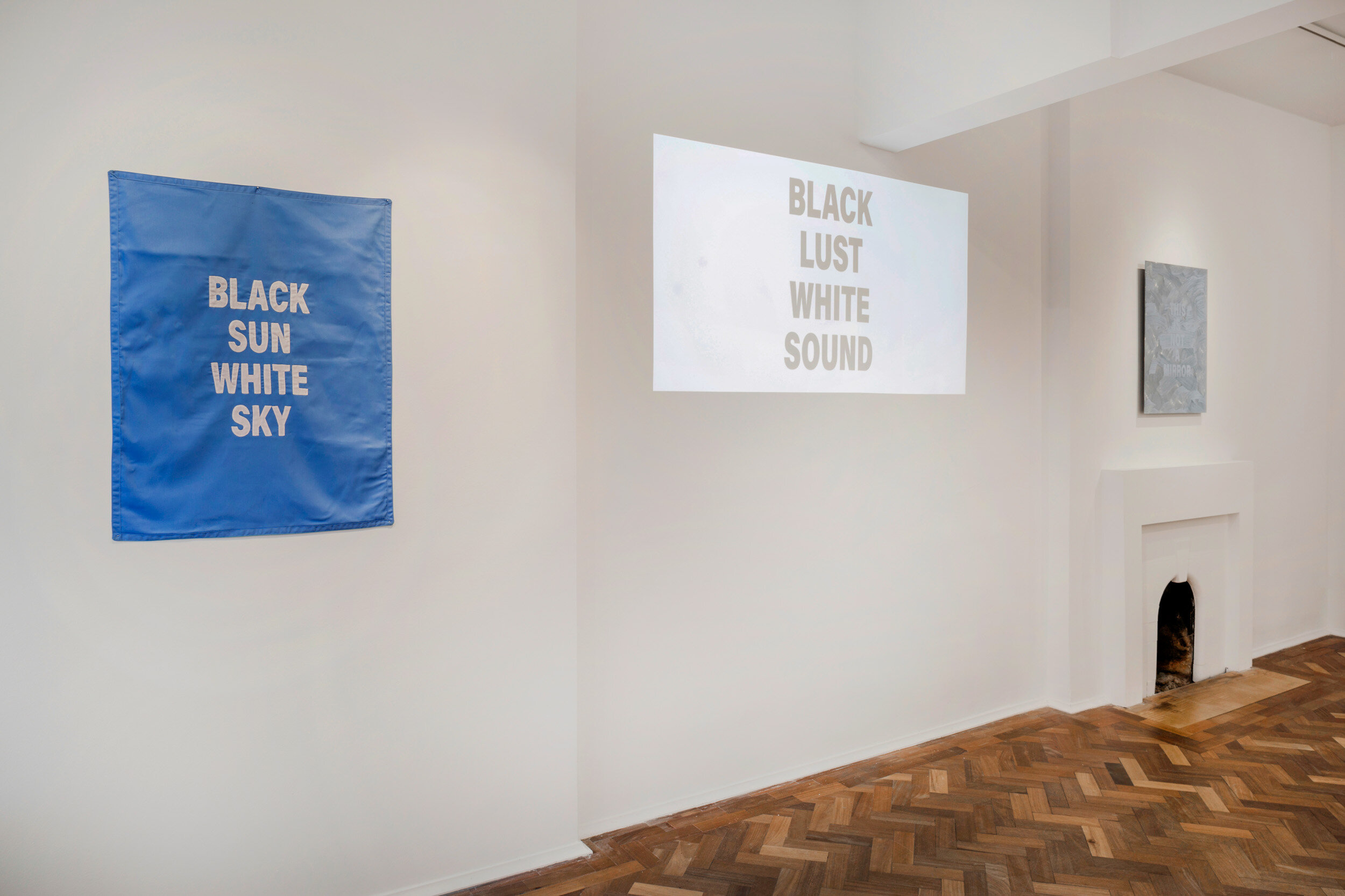  The poems are expressed or manifested in any possible form depending on the exhibition space, displayed on video, inscribed on paper, posters, books or mirrors, sewn, drawn, or spoken, printed on T-shirts and worn, performed rhythmically in morse co