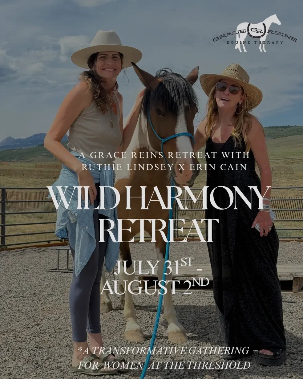 Two women smiling next to a horse outdoors in a rural setting with mountains in the background, promoting the WILD HARMONY RETREAT from July 31st to August 2nd by Grace Reins, Ruthie Lindsey, and Erin Cain.