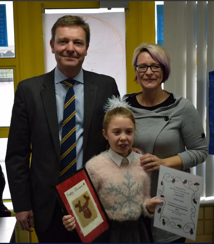 Craig presenting his Christmas Card 2017 Competition winner and Christ Church CE Junior School pupil, Darcie, with her winner’s certificate