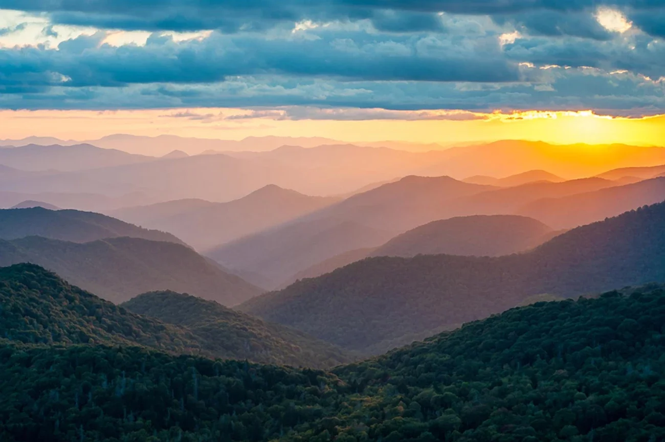 Green, rolling mountains at sunset