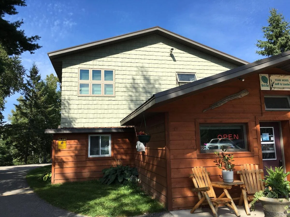 The two-story residence behind the office in summer