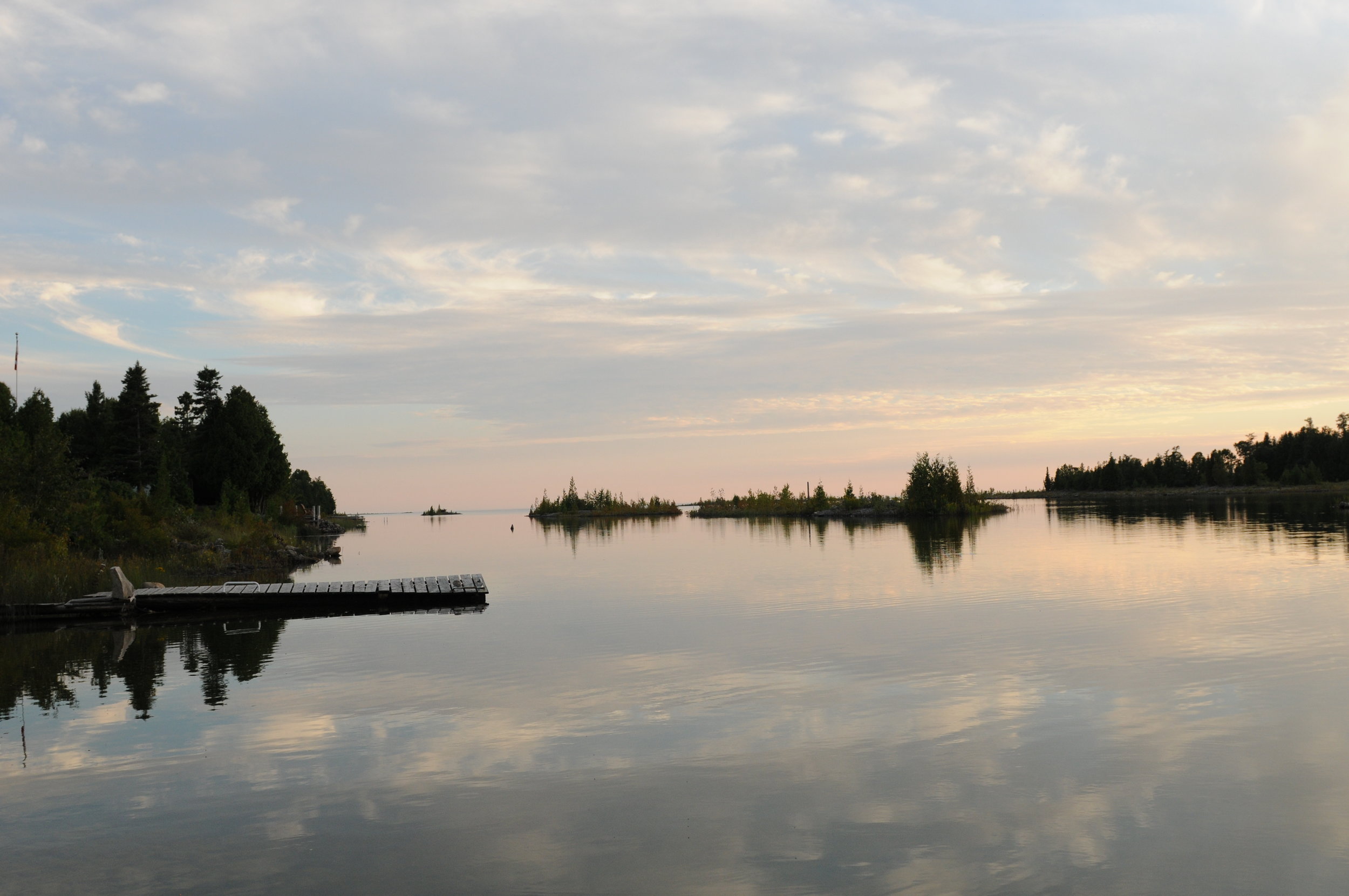 Dawn dusk clear water dock sky land stillness