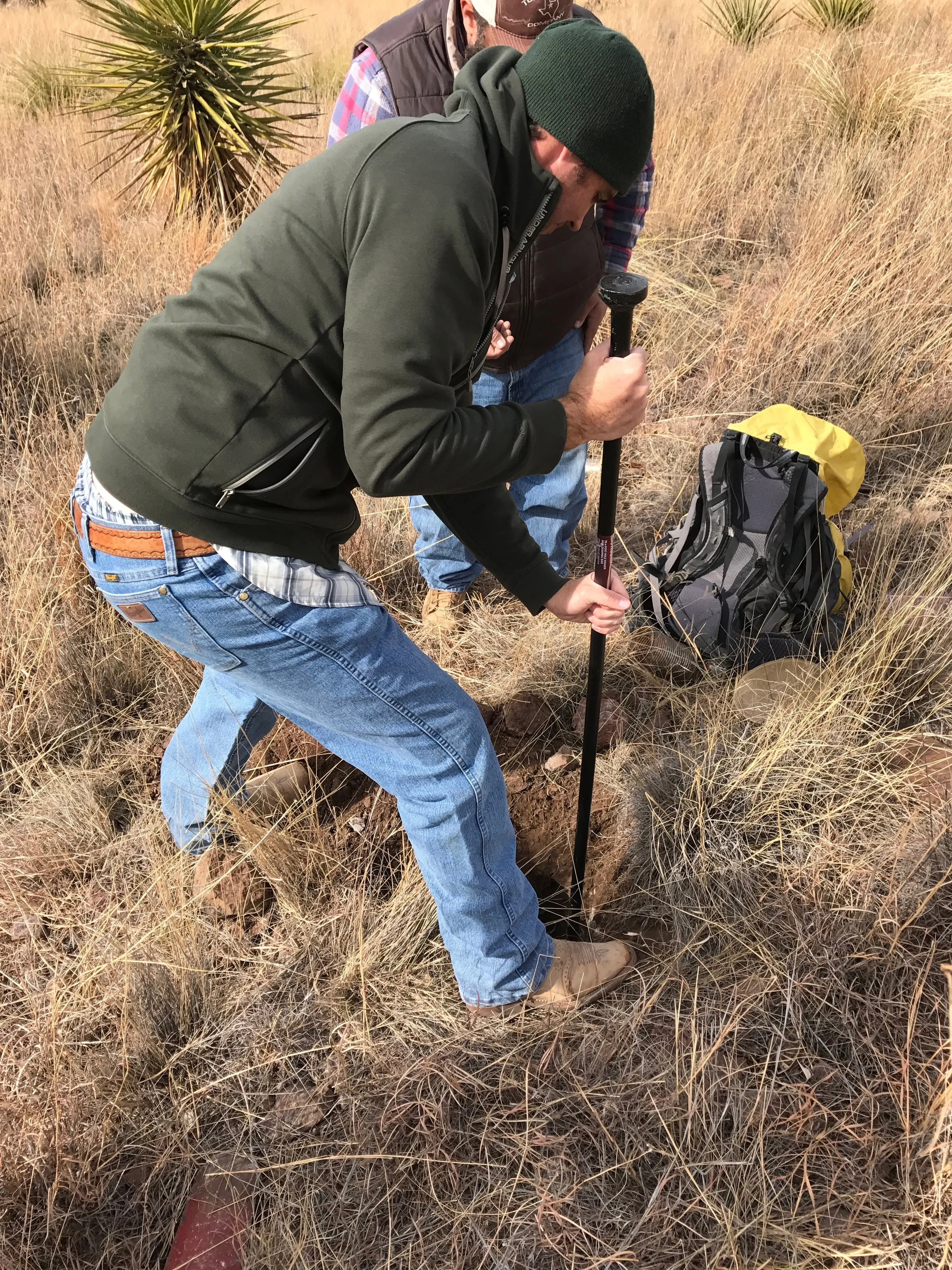 Will Juett, soil scientist from the NRCS in Marfa, digging through rocks.