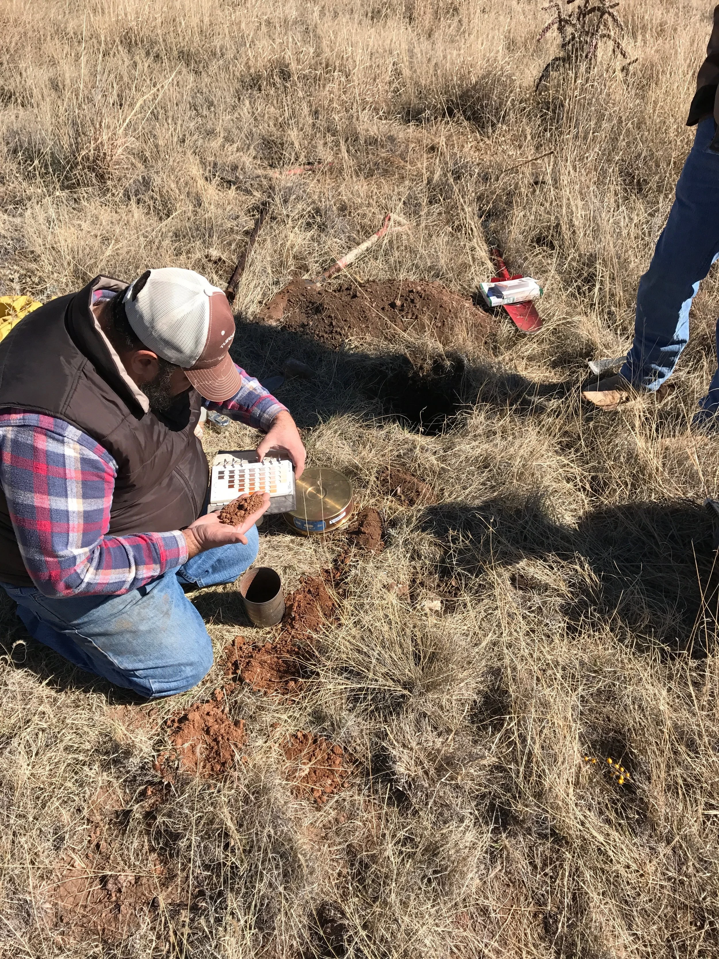 David Jalali, soil scientist from the NRCS in Marfa, classifying soil color.
