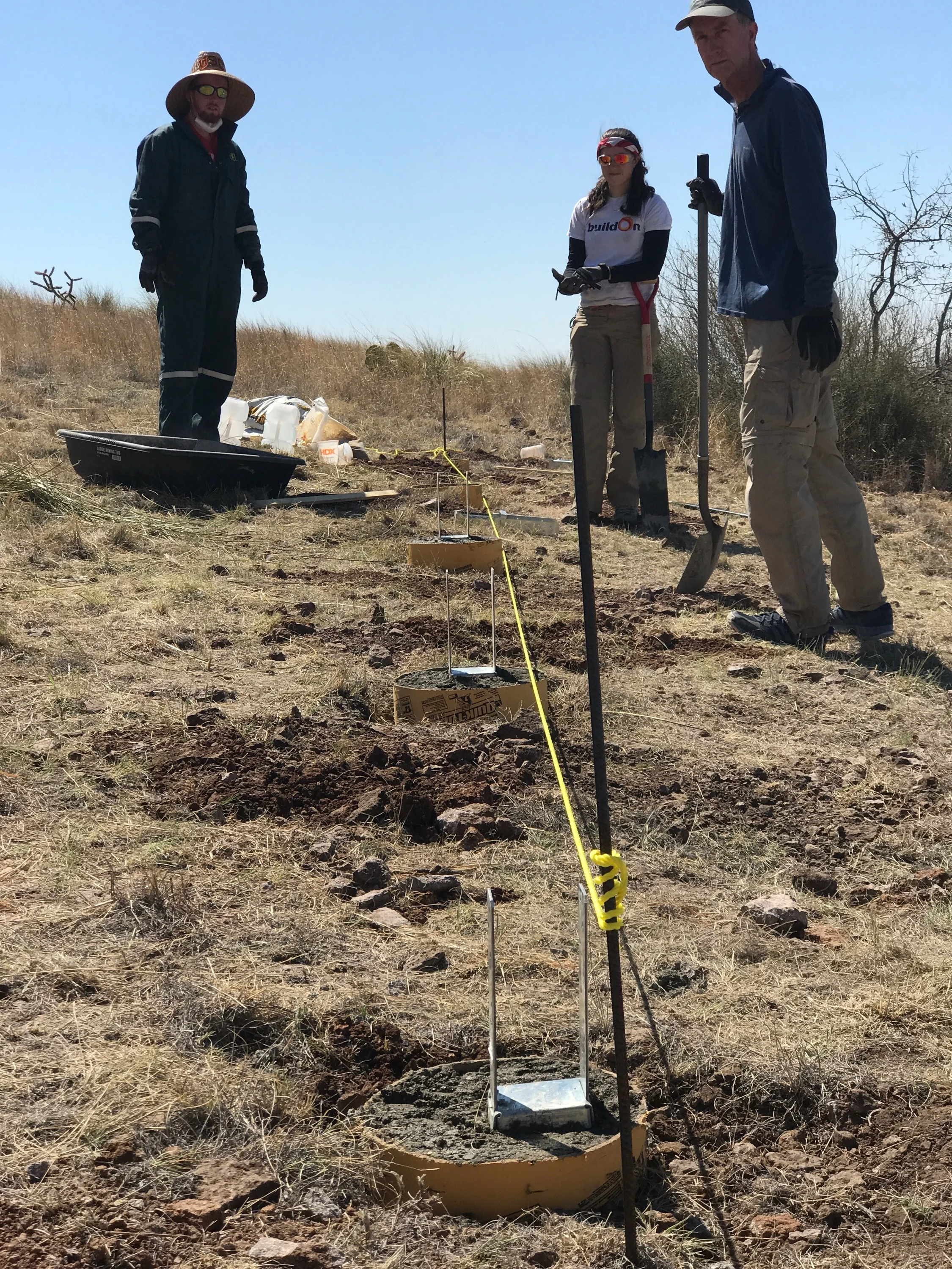 Here is the first line of footings. 18 inch deep by 12 inch diameter concrete footings will support the posts for the tent platform. Digging these five holse was quite a bit of work because of how rocky the soil is.