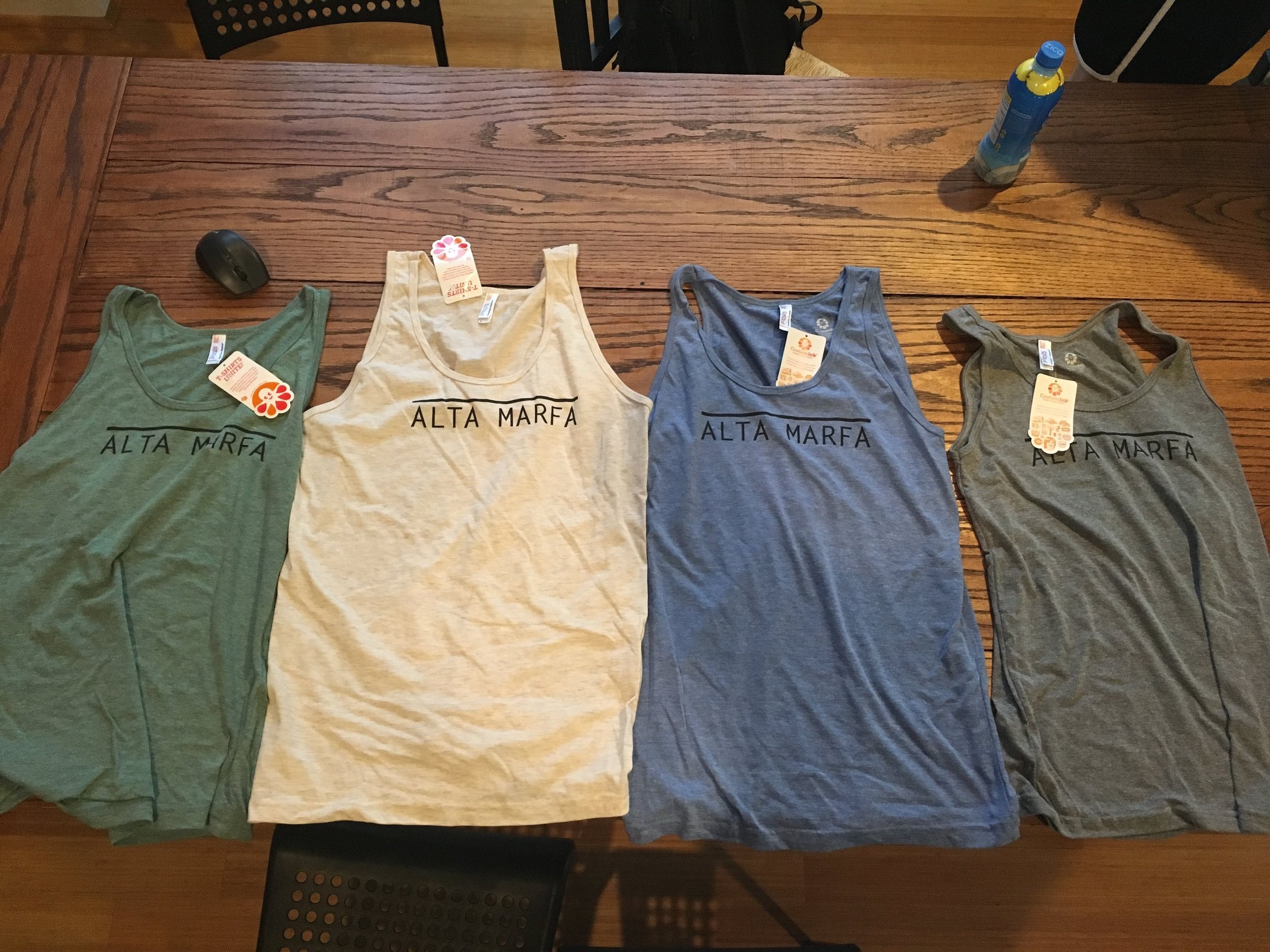 The shirts are American Apparel Tri-blend, they are super soft and run on the smaller side.