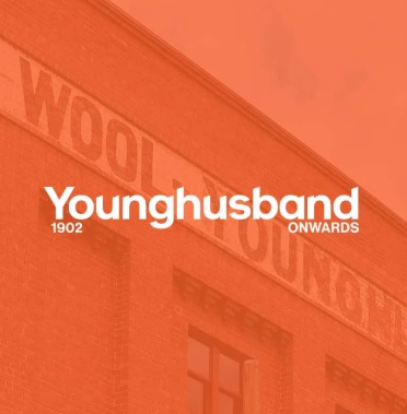 Red-tinted Younghusband 1902 Onwards graphic over a historic brick building facade