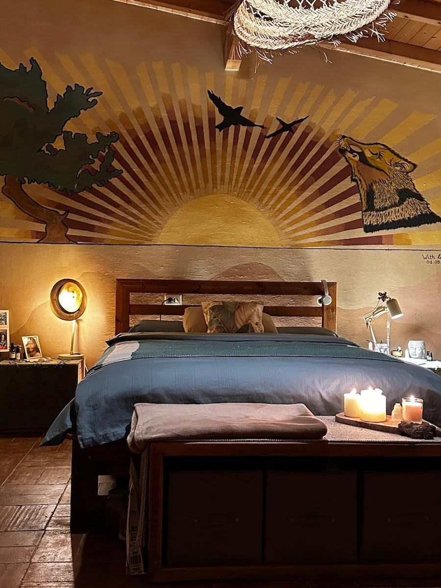por-do-sol-room-artistic-double-bed-sun-and-wolf-mural-off-grid-retreat.jpeg
