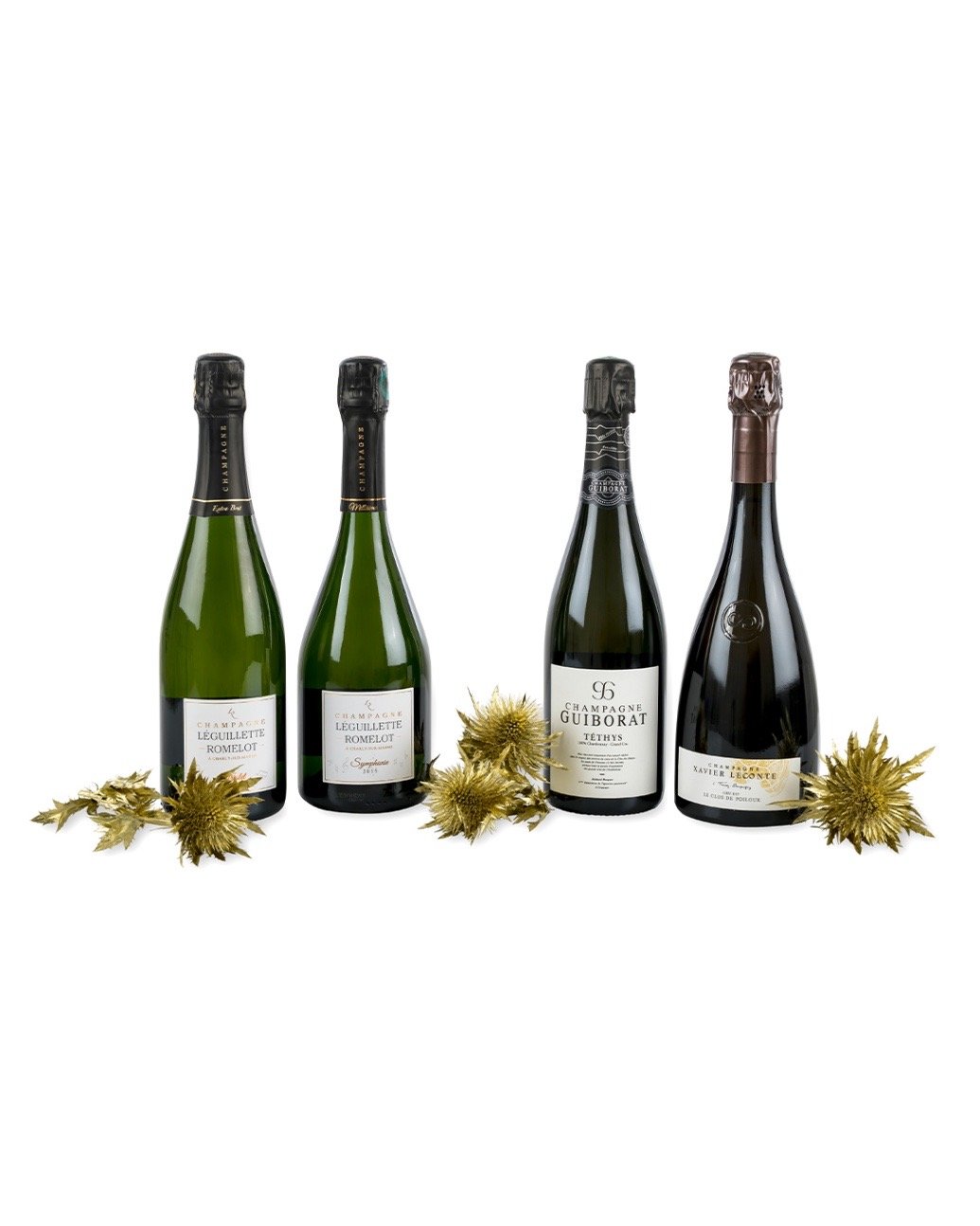 Vier Flaschen Champagner dekoriert mit vergoldeten Disteln