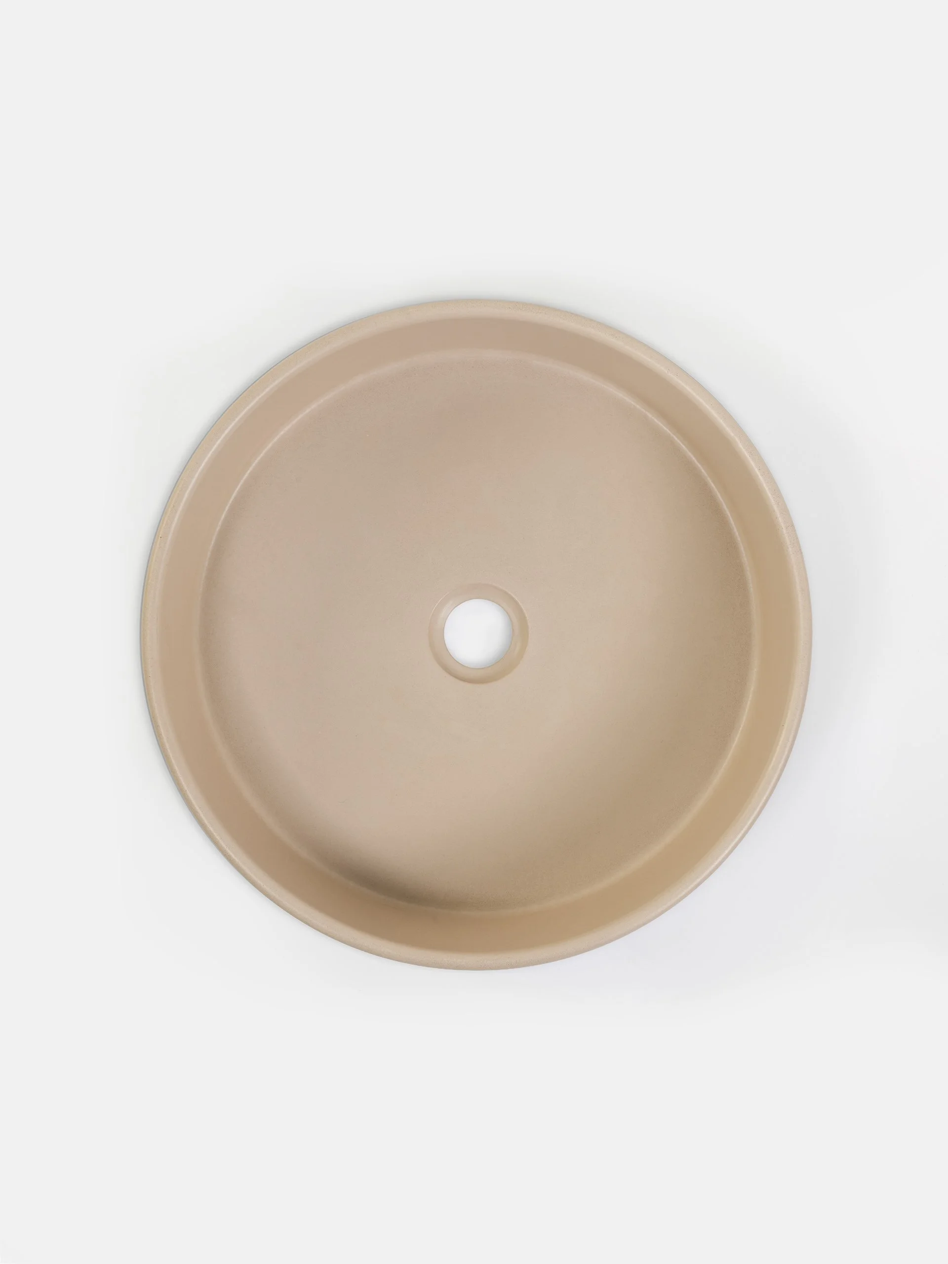 Top view of round concrete vessel sink in Dune